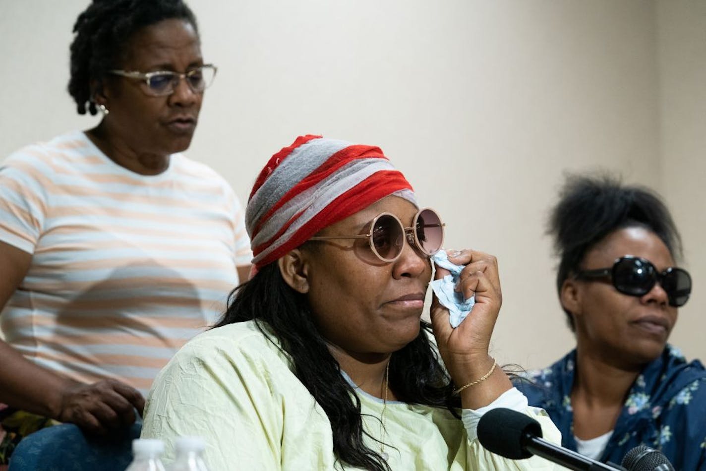 Essie McKenzie, flanked by her mother Shenna Galloway and sister Alexis McKenzie asked for prayers for her daughters who where trapped in a van fire Tuesday morning. She spoke Thursday at Hennepin Healthcare's HCMC.