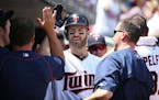 Minnesota Twins first baseman Joe Mauer was greeted by teammates after hitting a solo home run against the Cardinals in June.