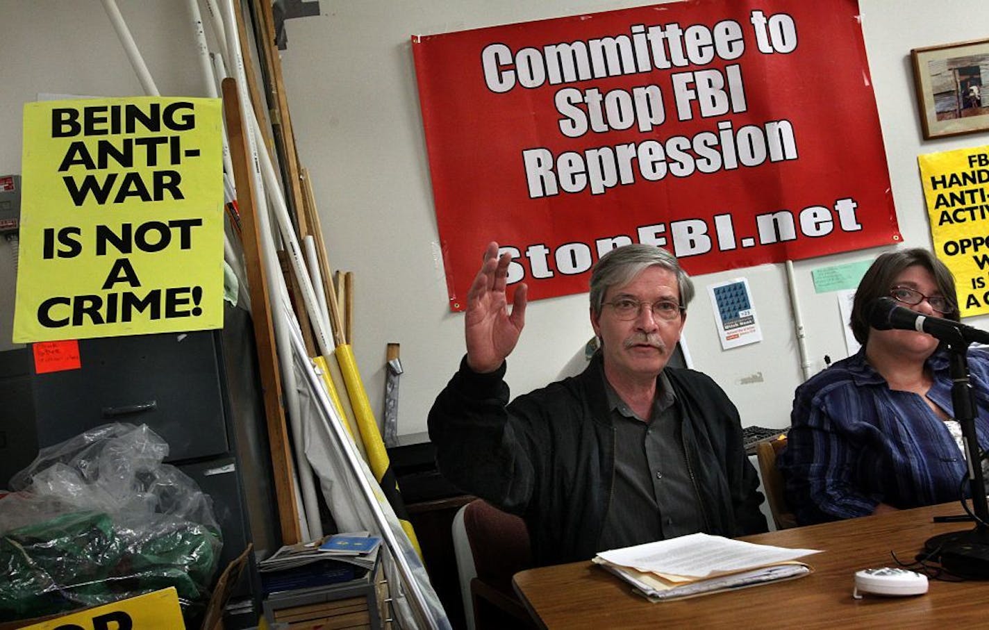 FILE -- Anti-war activists Mick Kelly (left) and Jess Sundin talked at a 2011 press conference about what they said were detailed plans regarding the FBI raids.