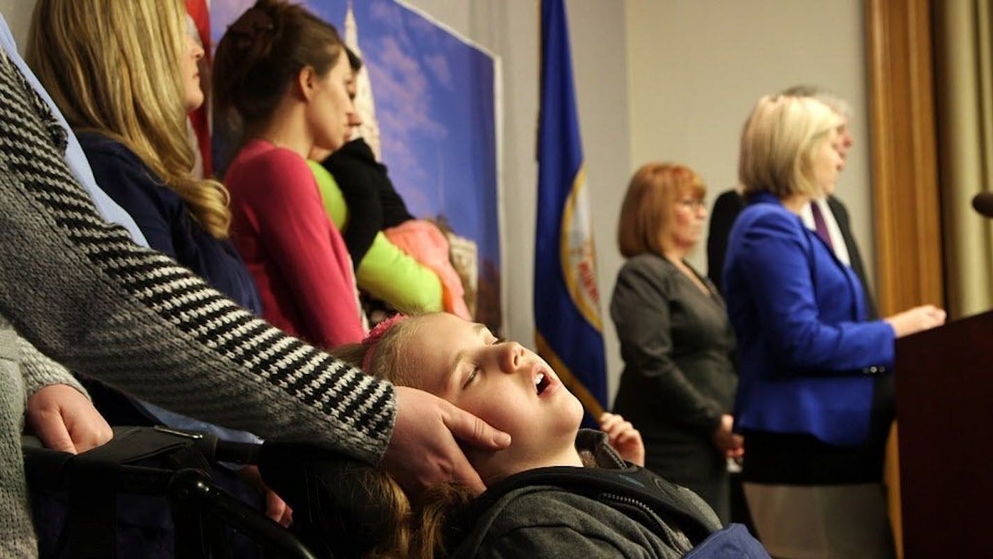 Katelyn Pauling, 7, has epilepsy and Batten's Disease. Pauling said others with this condition have benefited from medical marijuana. Her mother Kristy Pauling is touching Katelyn's face. They were at press conference where House Speaker Paul Thissen, Majority Leader Erin Murphy and Rep. Carly Melin announced they have reached a compromise that could conclude what has been one of the this year's most contentious issues.