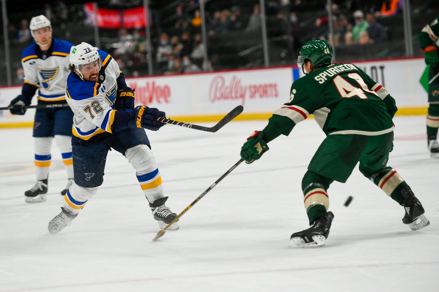 St. Louis Blues defenseman Justin Faulk (72) shoots past Minnesota Wild defenseman Jared Spurgeon during the second period of an NHL hockey game Wednesday, April 28, 2021, in St. Paul, Minn. (AP Photo/Craig Lassig)