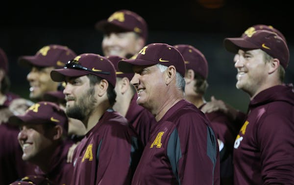 Minnesota head coach John Anderson posed with his team for a photo after winning his 1200 games at Siebert Field Tuesday May 3, 2016 Minneapolis, MN.]