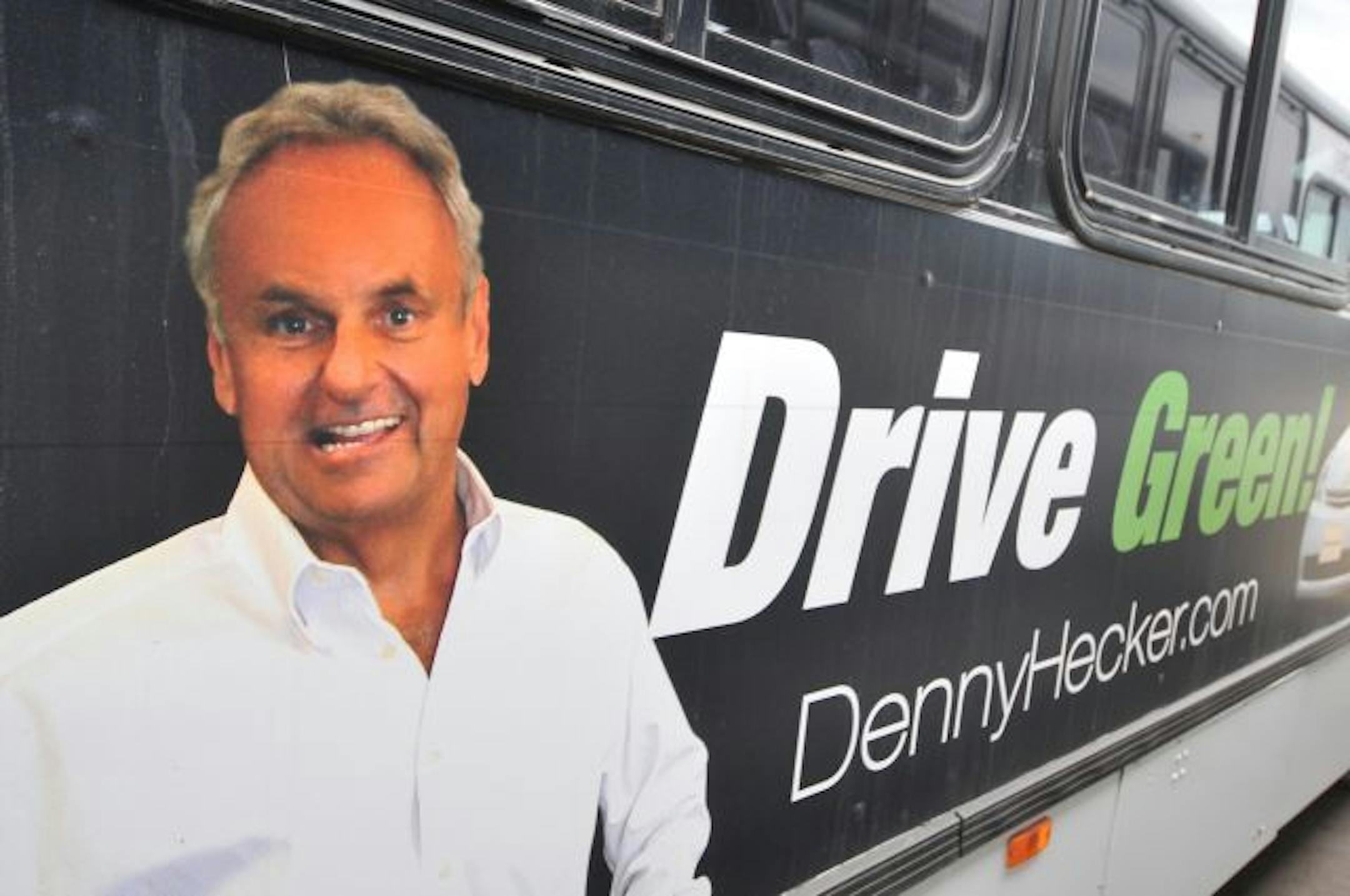 Denny Hecker advertisement on the side of a Metro Transit bus.