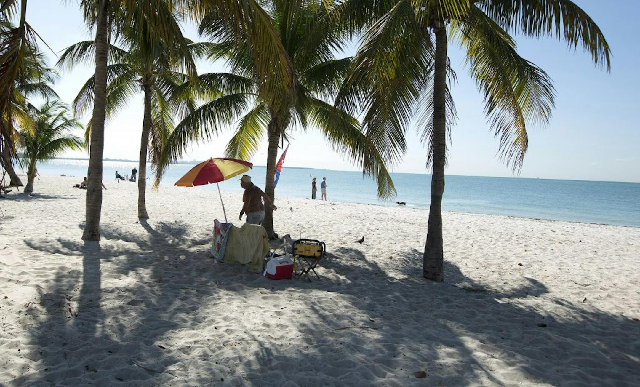 Beach goers enjoy the sand and water Thursday, Jan. 24, 2013 on Key Biscayne, Fla., with light winds and temperatures in the mid 70s.