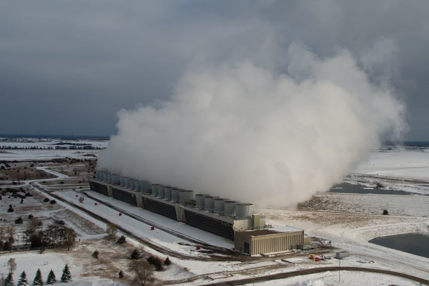 Cooling towers at the Sherburne County Generating Station emit plumes of steam. Minnesota Power is close to retiring 700 megawatts of coal generation over the past several years.