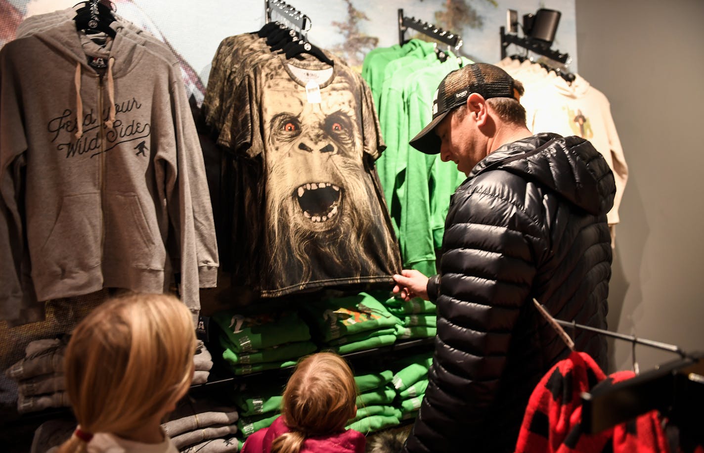 Mitch Hoffman, showed a Sasquatch shirt to his daughters Hannah, 6, and Ella, 8, as they perused the selection of Sasquatch merchandise at Wild Side, Jack Link's Jerky's new retail space at Target Center. ] AARON LAVINSKY &#xef; aaron.lavinsky@startribune.com Jack Link's Jerky just opened their retail store, "Wild Side," inside of the redesigned Target Center. We photograph the store on Friday, Nov, 10, 2017 in Minneapolis, Minn.