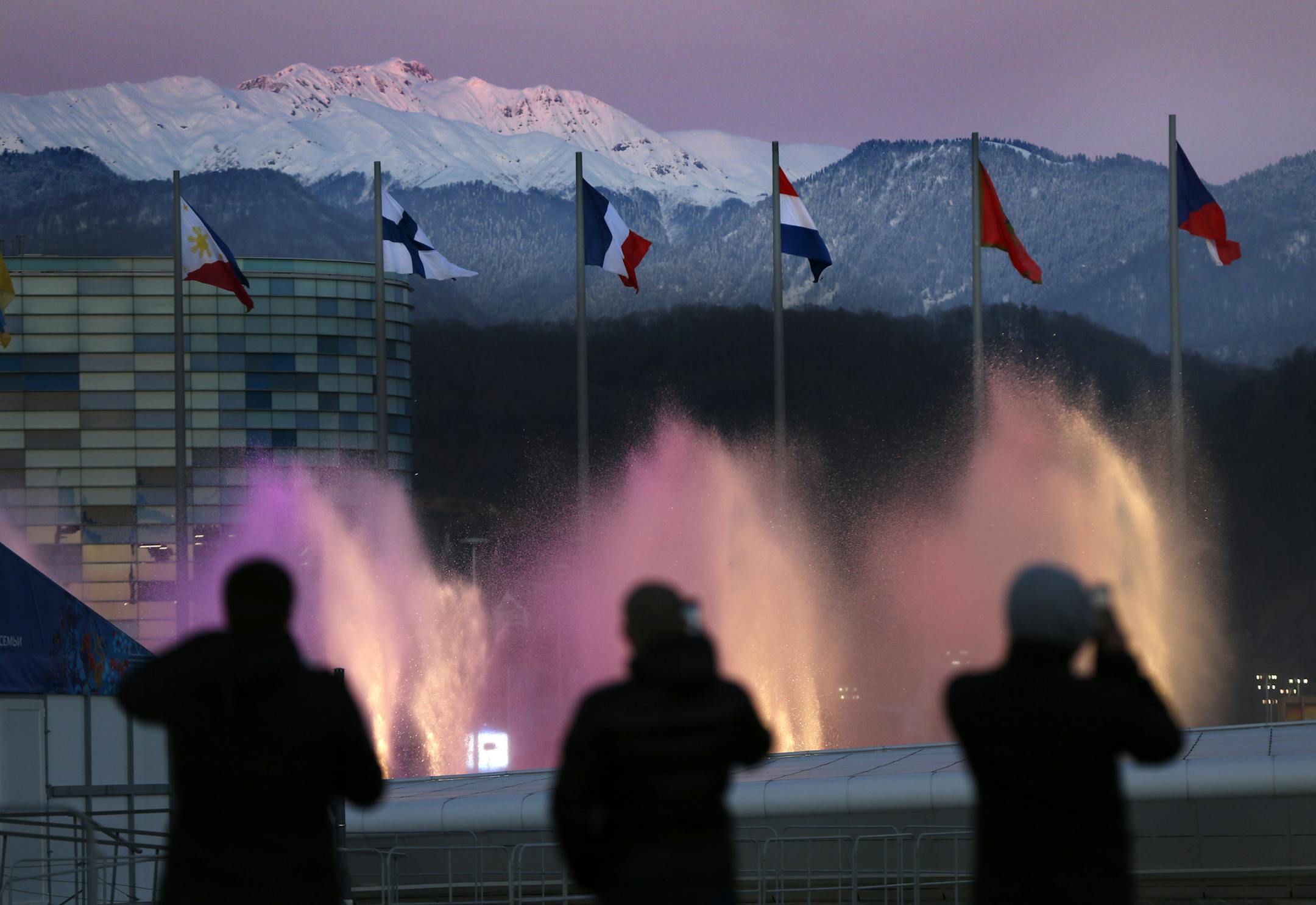 Spectators photograph water fountains at Olympic Park during final preparations before the 2014 Winter Olympics, Monday, Feb. 3, 2014, in Sochi, Russia. The opening ceremony for the games is Feb. 7, and the competition will run until Feb. 23. (AP Photo/Robert F. Bukaty)