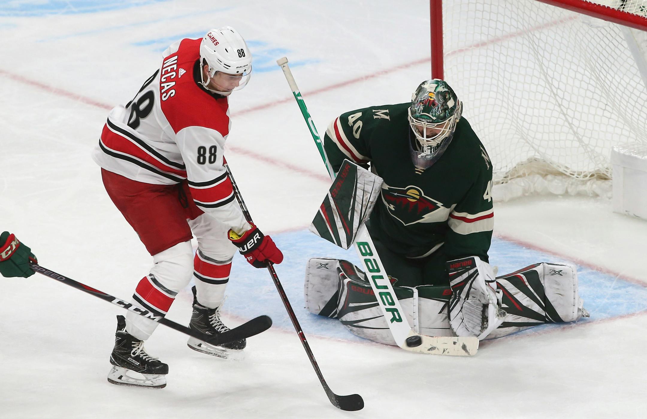 Minnesota Wild goalie Devan Dubnyk stops a shot by Carolina Hurricanes' Martin Necas, of the Czech Republic, during the third period of an NHL hockey game Saturday, Oct. 13, 2018, in St. Paul, Minn. The Hurricanes won 5-4 in overtime. (AP Photo/Jim Mone)