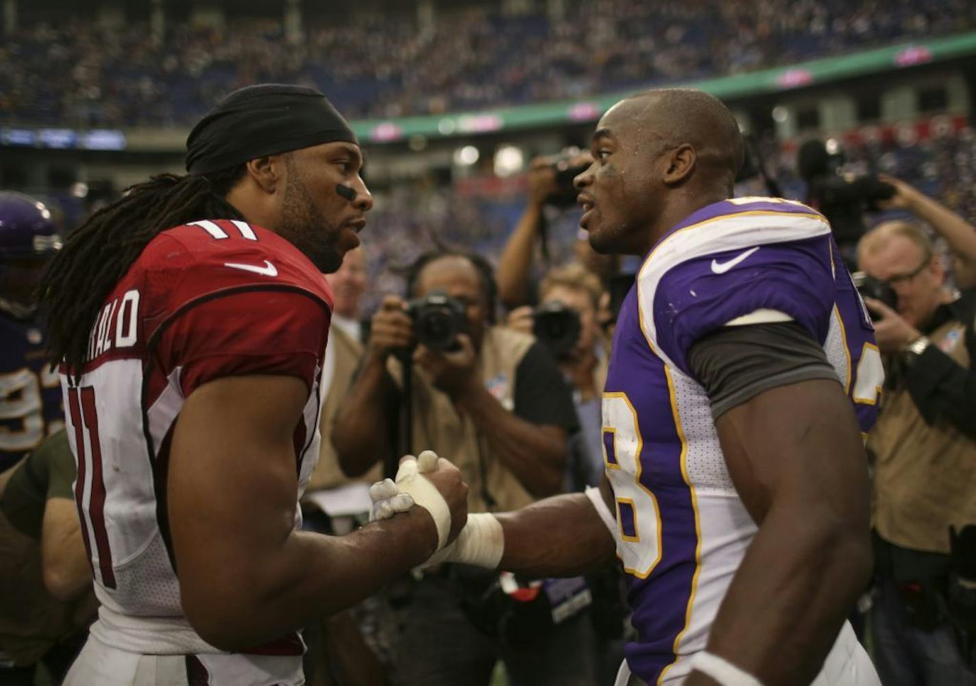 Larry Fitzgerald Jr. and Adrian Peterson talked after their teams played in 2012.