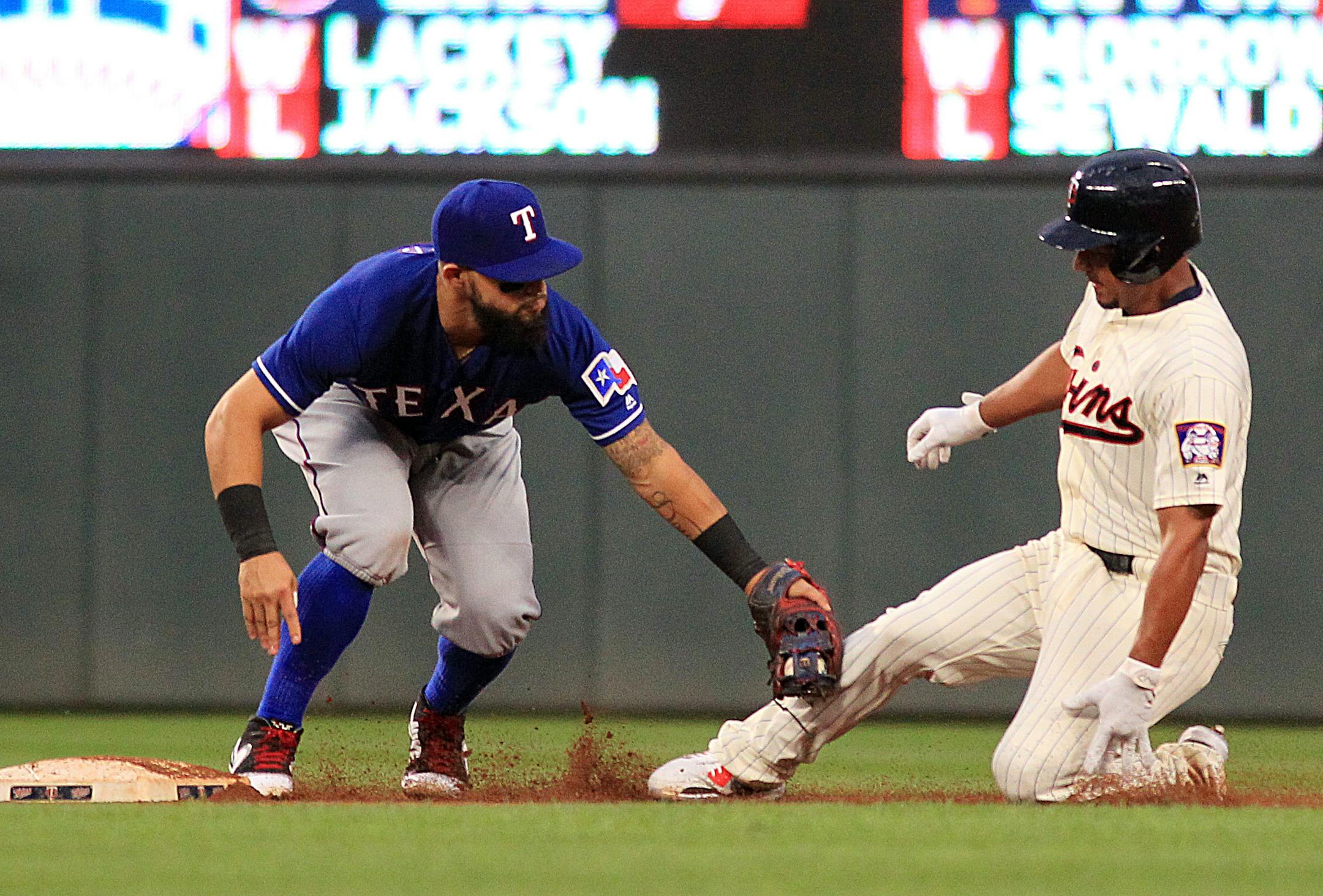 Minnesota Twins' Eduardo Escobar (5) is tagged out at second by Texas Rangers second baseman Rougned Odor (12) while trying to stretch a hit out in the fourth inning during a baseball game on Saturday, Aug. 5, 2017 in Minneapolis. (AP Photo/Andy Clayton-King)