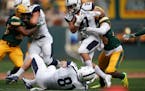 Butler Bulldogs running back AJ Deinhart (21) was brought down by North Dakota State Bison cornerback Josh Hayes (14) as he ran the ball in the first 
