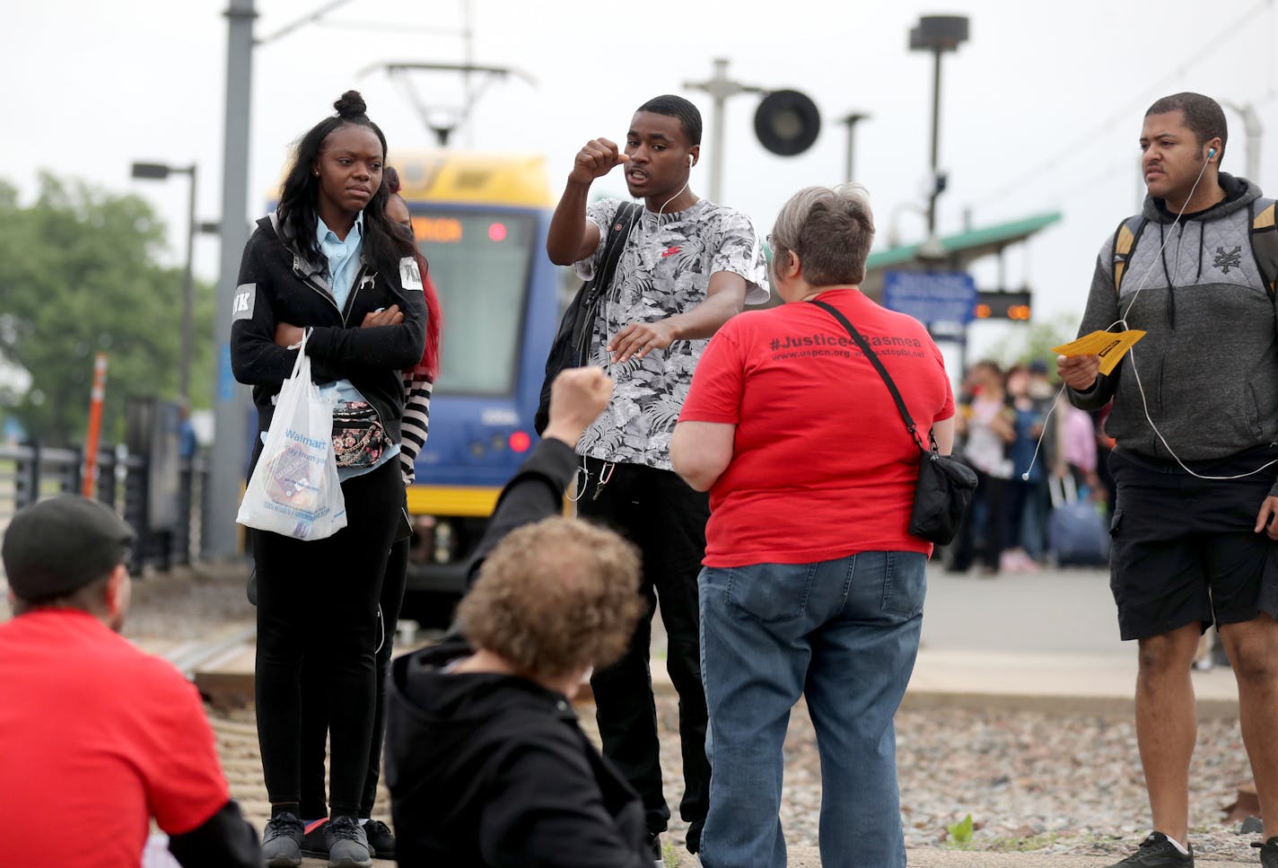 A light-rail commuter, rear center, who said he had been trying to get to work, raises his fist at protestors blocking the train tracks Tuesday, May 22, 2018, in Minneapolis, MN. Eighteen protestors were arrested by law enforcement officers for blocking the Blue Line light-rail tracks at the Fort Snelling station. The protest was in response to ICE raids and deportations of undocumented immigrants in the U.S.] DAVID JOLES &#xef; david.joles@startribune.com protestors shut down light rail at Fort