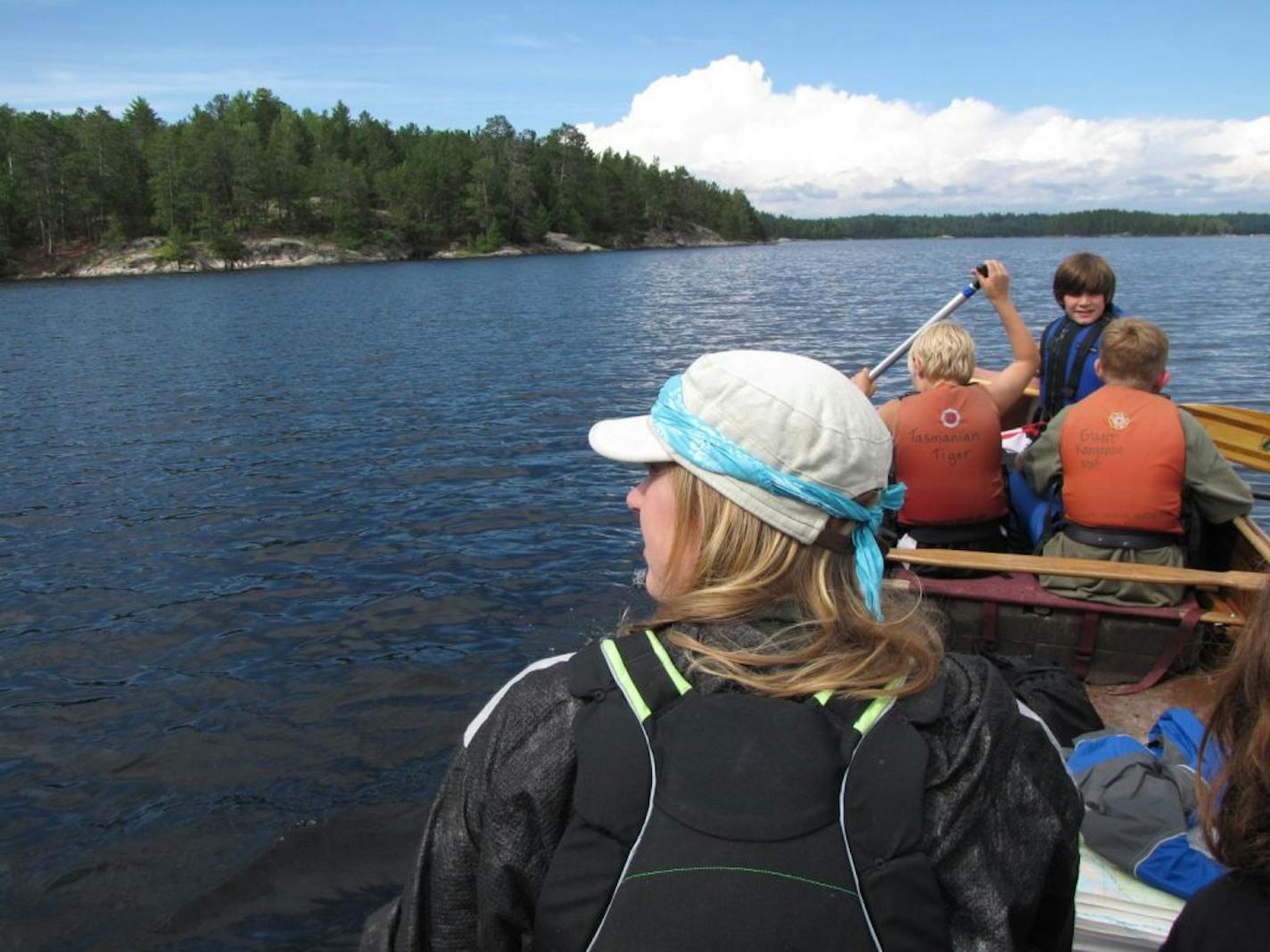 Guide Kate Sinner helps get a crew across Lake Kabetogama on the way to camp at Big Sky Island.