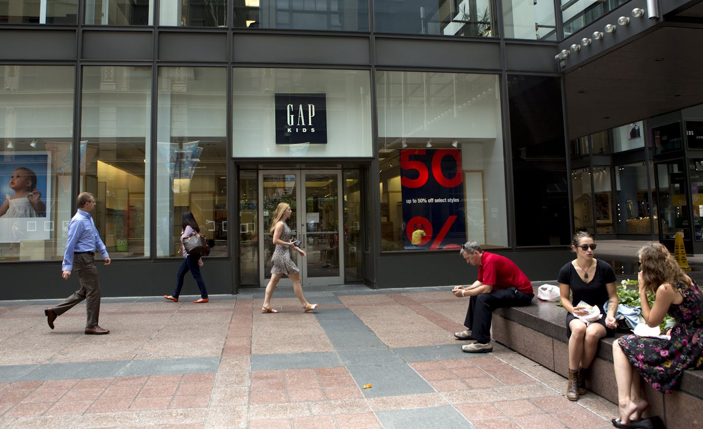 People walk by and eat lunch outside of Gap Kids at 7th and Nicollet Mall in Minneapolis, Minn., Monday, July 13, 2015. The IDS Center location of Gap is closing.] KAYLEE EVERLY kaylee.everly@startribune.com