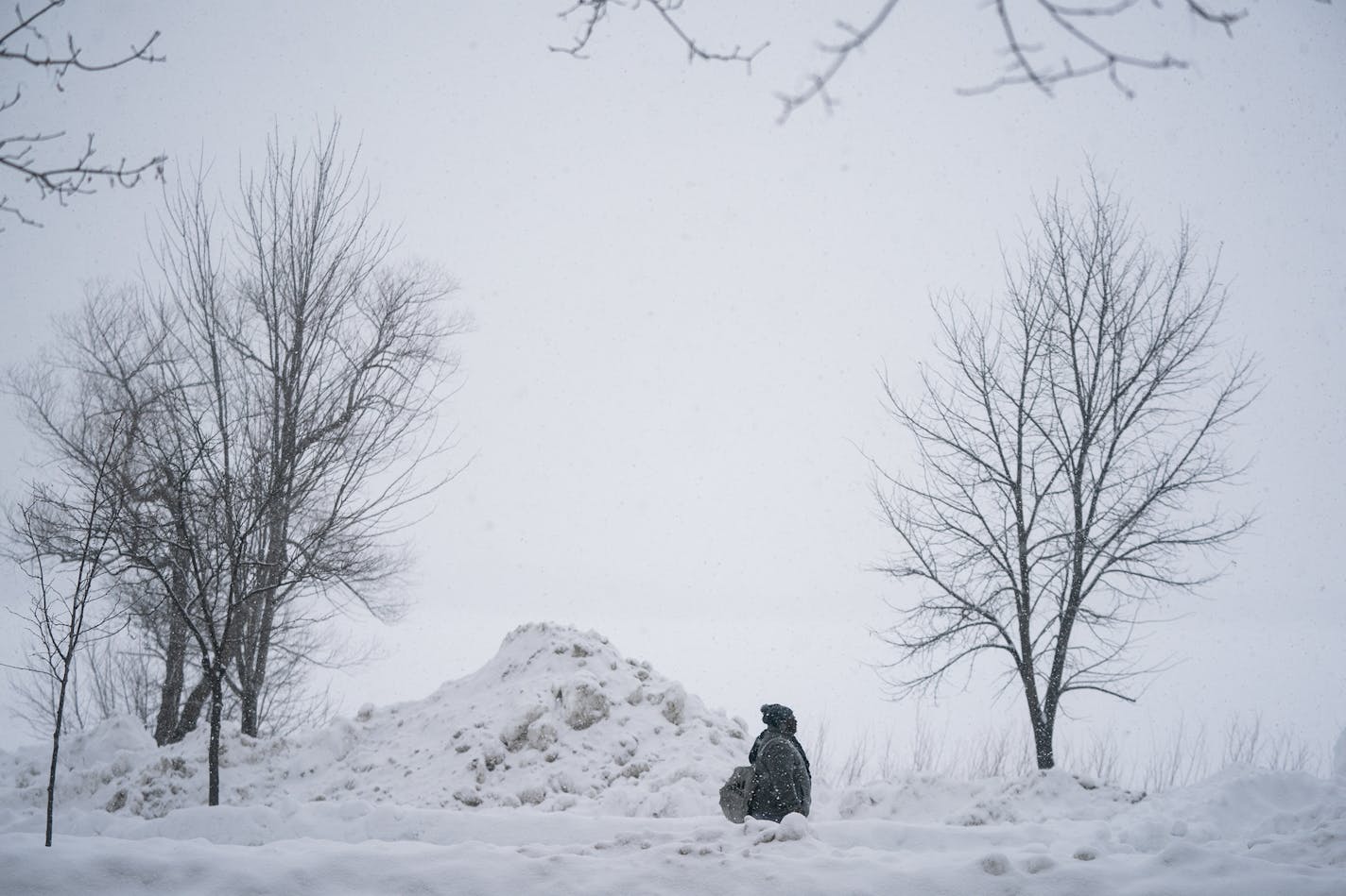 A pile of plowed snow dwarfs a pedestrian along Bde Maka Ska. ] LEILA NAVIDI &#xa5; leila.navidi@startribune.com BACKGROUND INFORMATION: Cool School Plunge + Super Plunge, part of the Minneapolis Polar Plunge's Frozen Friday events at Thomas Beach on Bde Maka Ska in Minneapolis on Friday, March 1, 2019. Snow accumulating 2-4 inches is predicted for the first day of March, followed by cold temperatures.