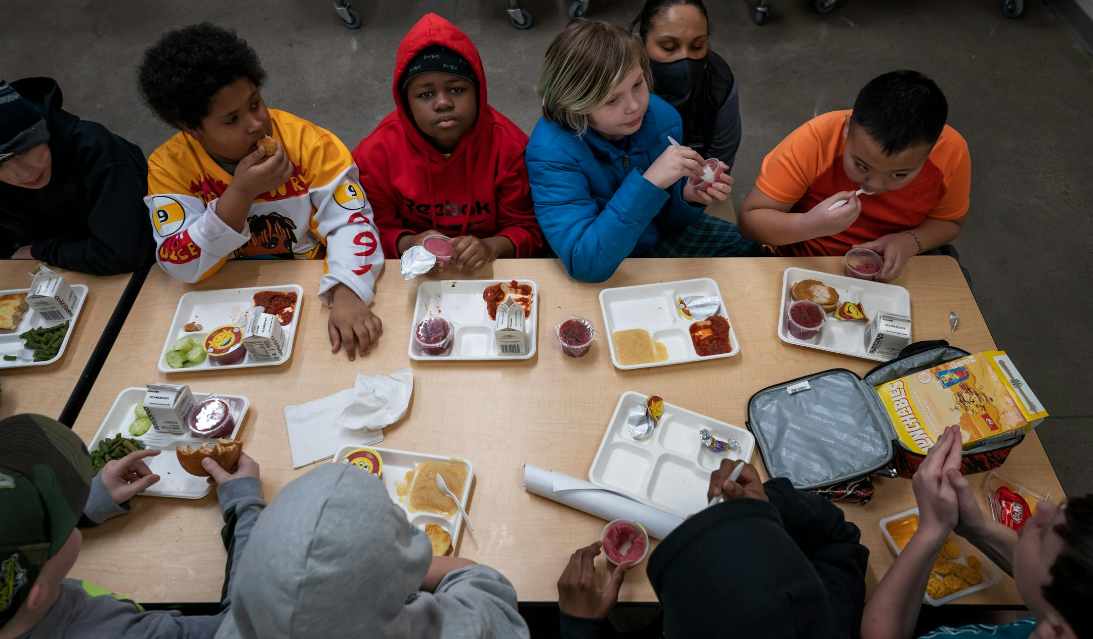 Fifth graders ate school lunch at Champlin-Brooklyn Park Academy on Friday, Feb. 17, 2023 in Champlin, Minn.
