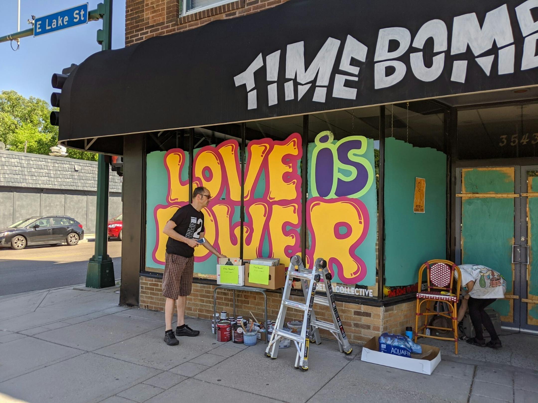 Artist Laura Geiselman was on her third day of painting the windows of Time Bomb Vintage at 3543 E. Lake St. Any donations she receives goes toward buying more painting supplies. "We all just need to help each other right now," she said.