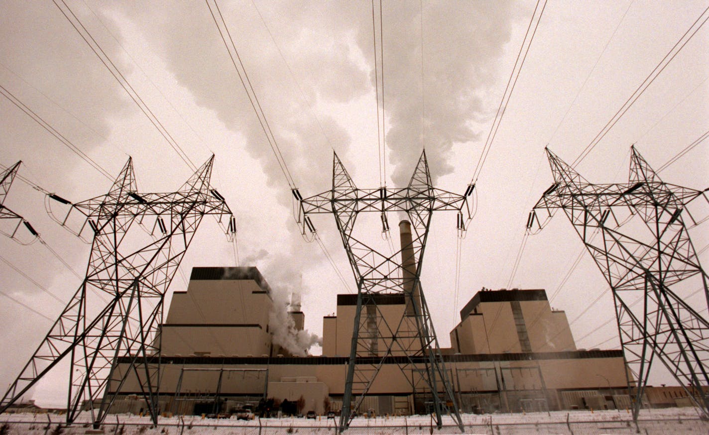 GENERAL INFORMATION: The Sherco Generating Plant in Becker, Mn.
IN THIS PHOTO: Becker, Mn., Sat., Dec. 30, 2000--(The buildings, left to right) Units 3, 2 and 1 of the Sherco Generating Plant in Becker, Mn., The transmission towers in front of the units are part of the Sherco Substation. Transmission lines carry electricity from the power plant to the substation. There the voltage is lowered before feeding it to a distribution system. Transformers provide correct voltage for customers.