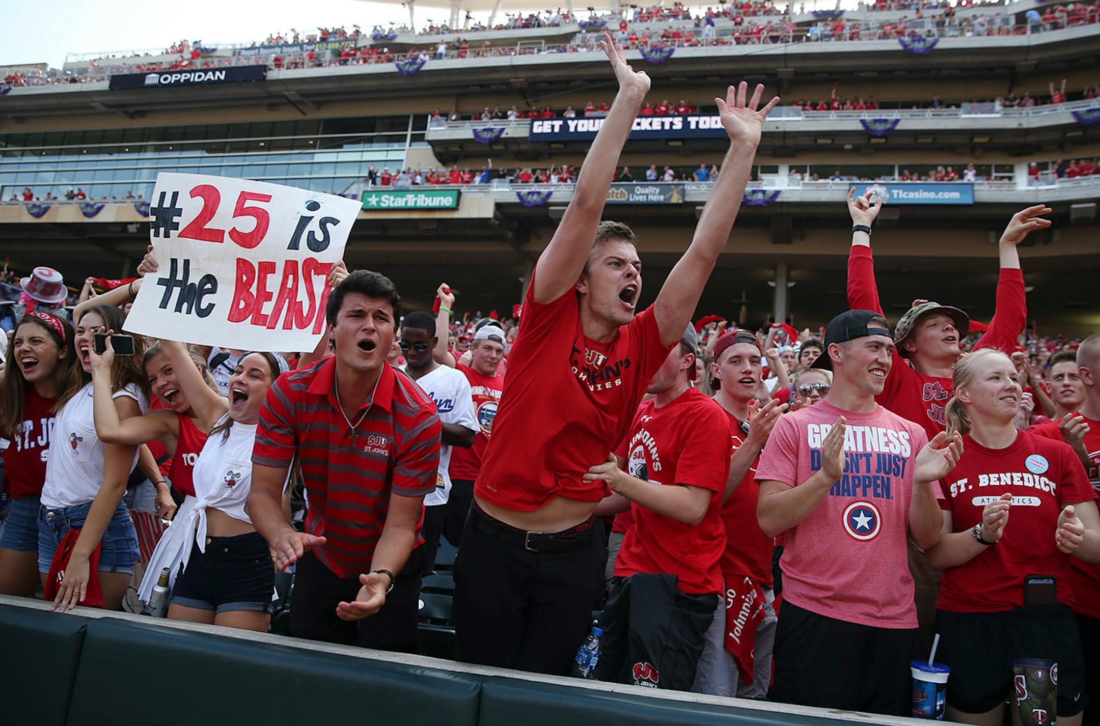 St. John's University fans reacted after tight end Jared Streit (81) ran the ball in for a touchdown off a long pass in the first half.