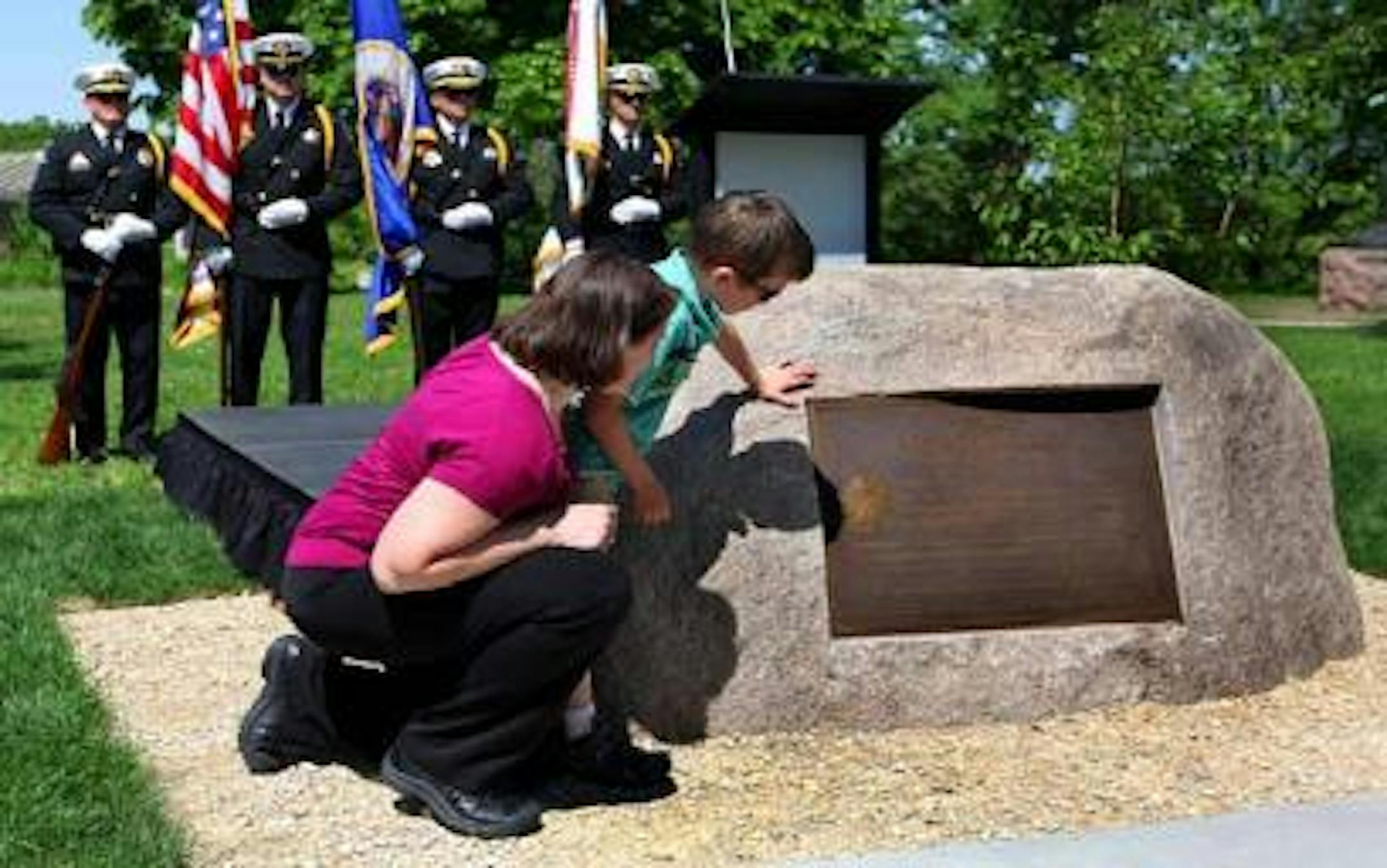 Family members attended the unveiling of a memorial to Mark Bedard, a Minneapolis Park Police officer who died in the line of duty in 2007. Bedard's widow, Andrea Mathieu, and son, Nicholas, read the inscription on the plaque.