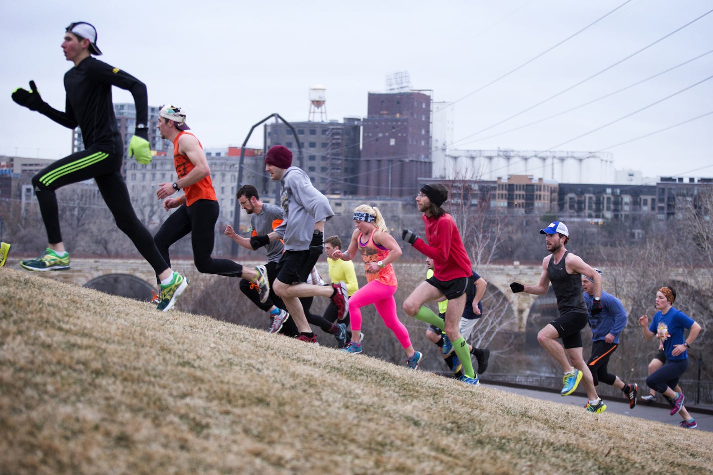 The November Project workout group runs hill sprints at Gold Medal Park in downtown Minneapolis on Wednesday, April 8, 2015. ] LEILA NAVIDI leila.navidi@startribune.com / BACKGROUND INFORMATION: The November Project is a flash-mob style free workout movement that meets every Wednesday at 6:27 a.m. in downtown Minneapolis to work out and build community.