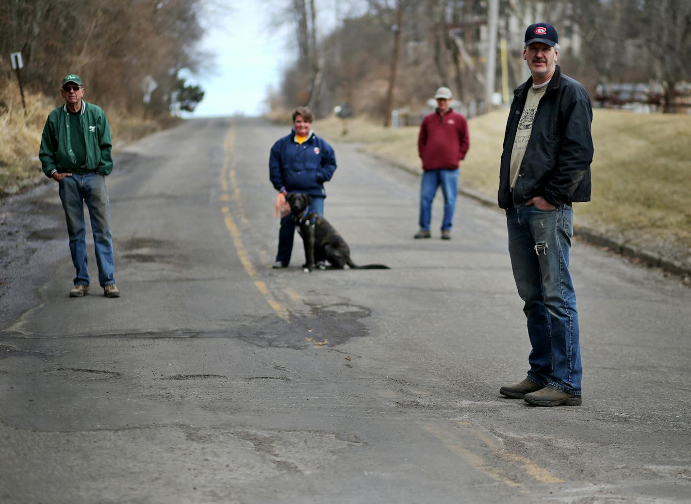 Residents of Old Cedar Avenue call it "the road Bloomington forgot." Until recently, now that the Old Cedar Avenue Bridge is going to be renovated for walkers and bikers, the city is going to also to rebuild the road with assessments for residents along the road proposed between $10,000 and $40,000. Here, the condition of the road as well as the proposed new road with it's big tax assessments is a topic of conversation for residents along the road, including Brad Pederson, left to right, his dau