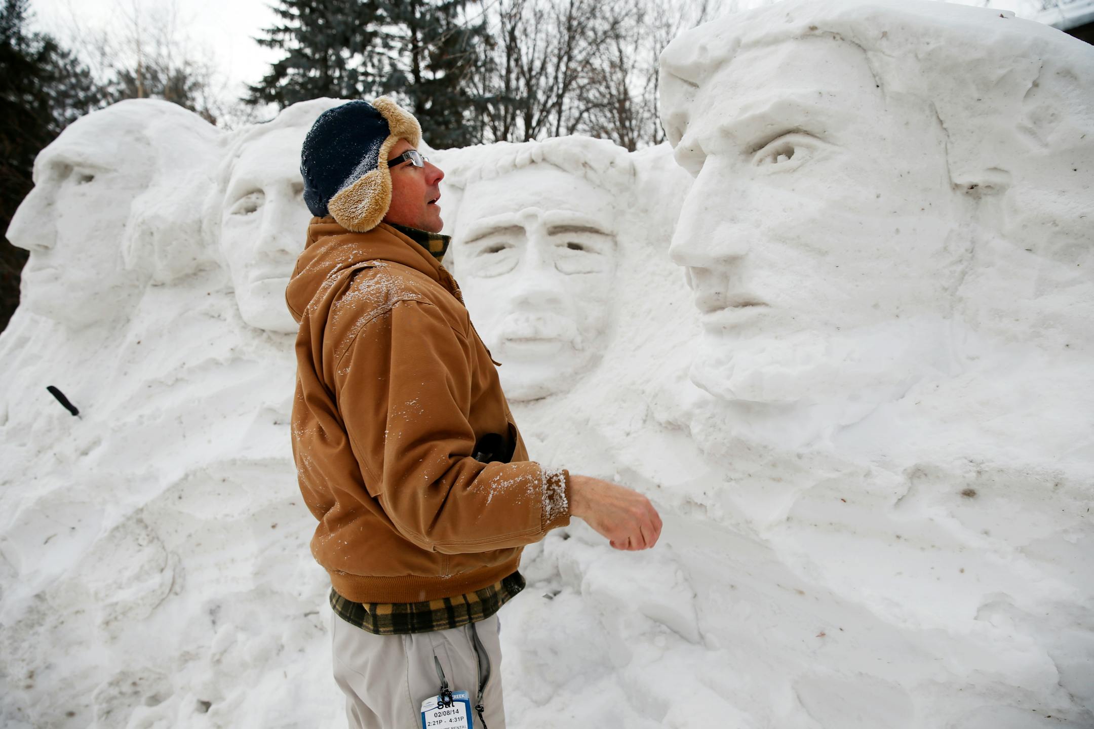Artist David Holmes creates a replica of Mount Rushmore out of snow in his front yard, Sunday, Feb. 16, 2014, in Minnetonka. His favorite carving is Lincoln, far right.