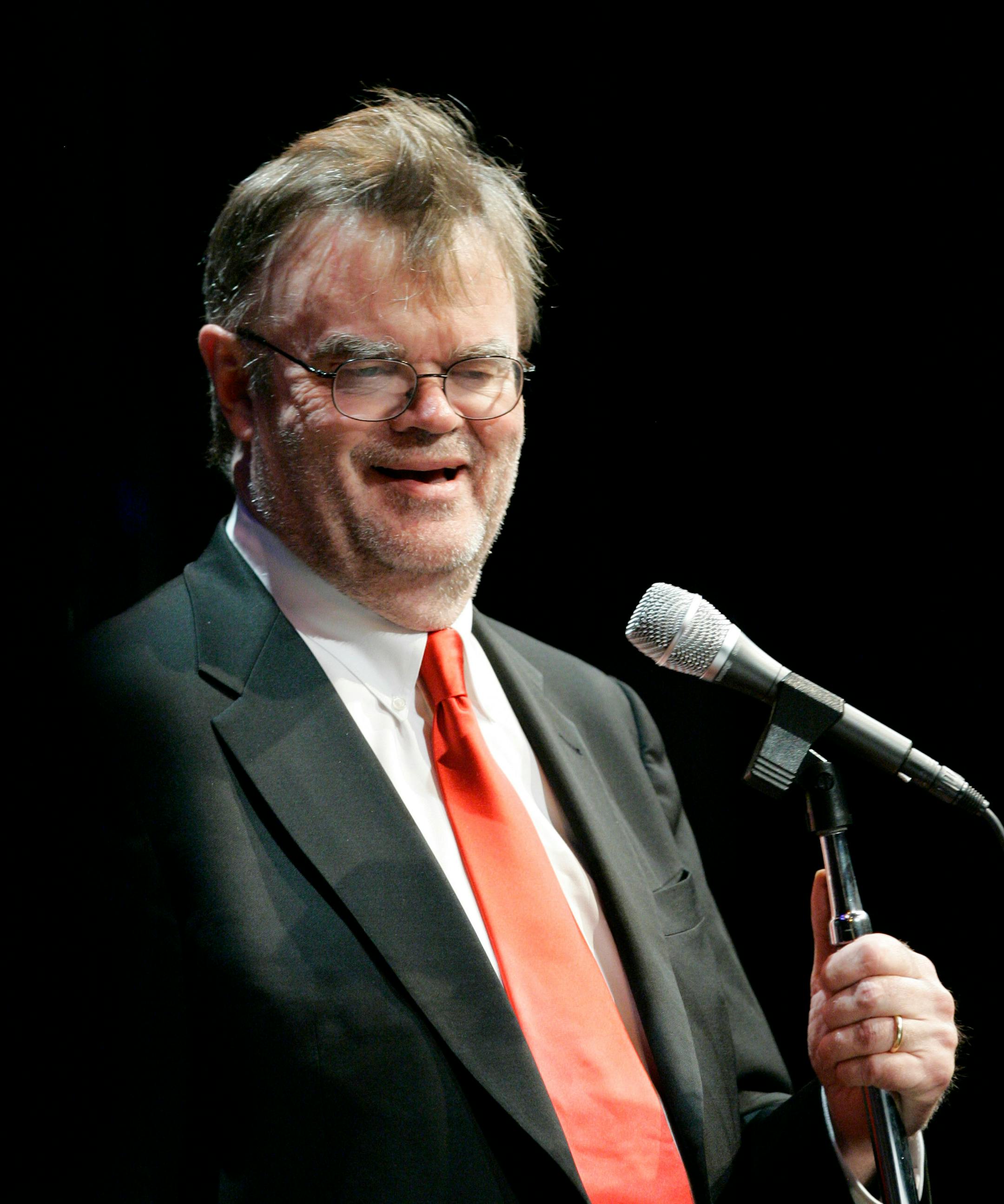 Garrison Keillor laughs during a live audience dress rehearsal of a Ruth the Librarian skit for "A Prairie Home Companion" at the Fitzgerald Theater in St. Paul, Minn., in this April 13, 2007, file photo. Keillor has gotten a restraining order against a Georgia woman he claims has made telephone calls and sent him explicit e-mails and disturbing gifts, including a petrified alligator foot and dead beetles. A Ramsey County District judge issued the order against Andrea R. Campbell, 43, of Hawkins