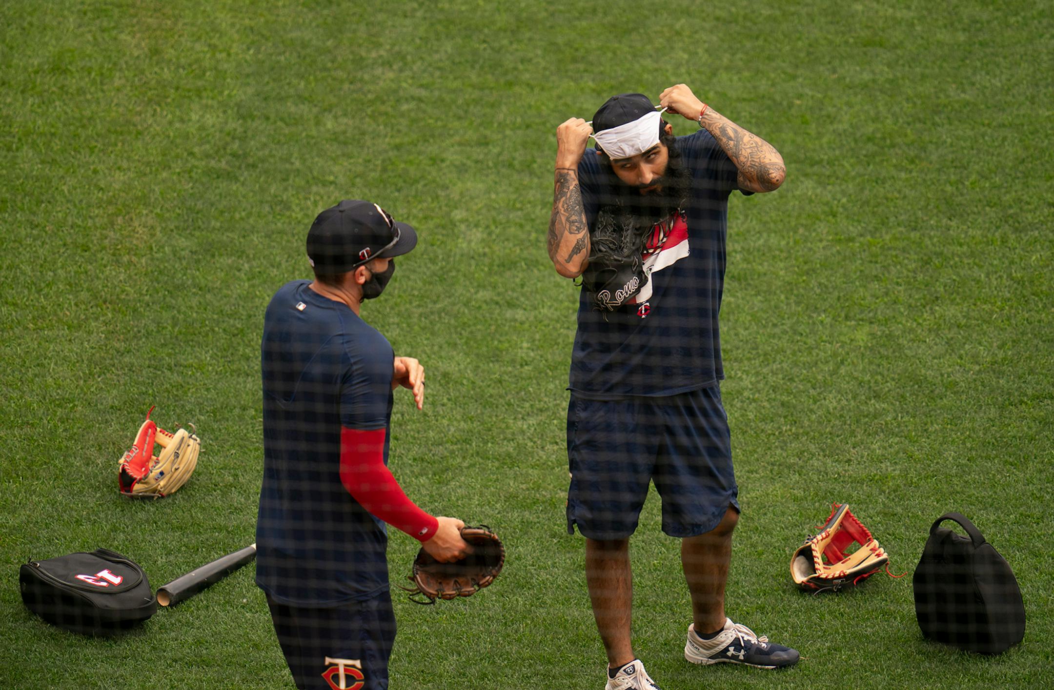 Minnesota Twins relief pitcher Sergio Romo (54) put on a face mask before pitchers took part in infield drills Monday afternoon. ] JEFF WHEELER • Jeff.Wheeler@startribune.com The Minnesota Twins held their fourth day of Summer Camp workouts Monday afternoon and evening, July 6, 2020 at Target Field in Minneapolis.