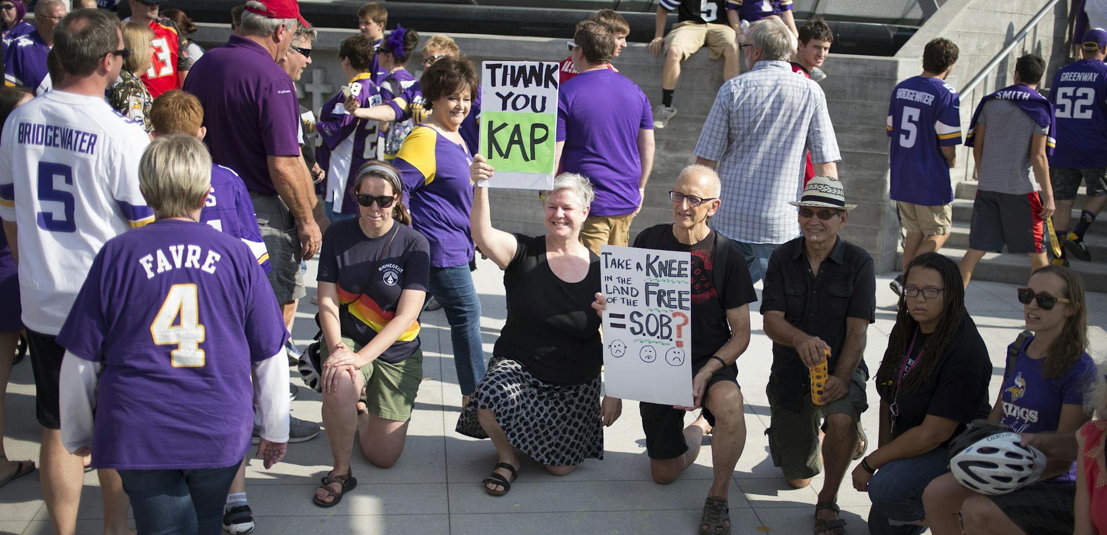 Linda Breitag left, and Ray Makeever held a sign up criticizing President Donald Trump's suggestion that they fire players who kneel for the national anthem, at U.S. Bank Stadium in Minneapolis on Sunday, Sept. 24, 2017. (Jerry Holt/Minneapolis Star Tribune/TNS) ORG XMIT: 1211808