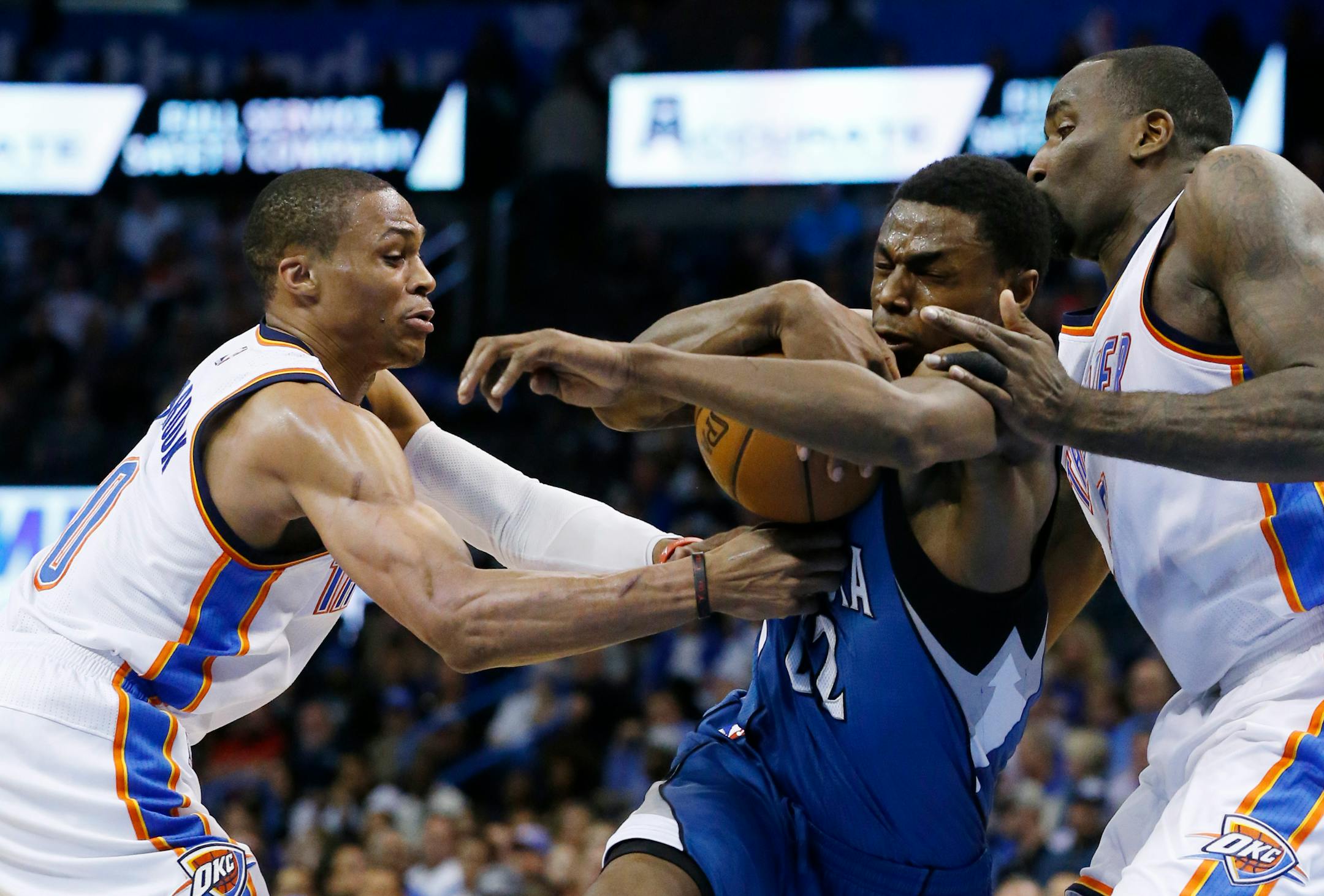 Timberwolves rookie Andrew Wiggins, center, drew the attention of Oklahoma City's Russell Westbrook, left, and Kendrick Perkins during Monday night's game. Wiggins led the Wolves with 23 points.