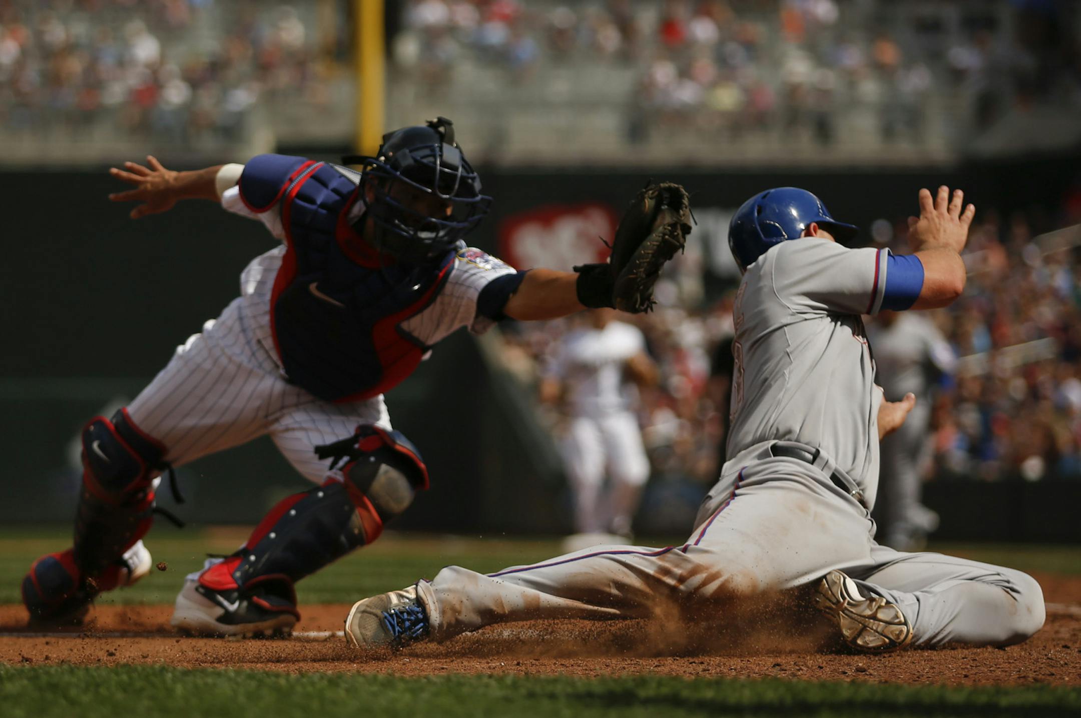 Chris Gimenez eluded the tag of Twins catcher Kurt Suzuki and scored on an eighth-inning on a single by Leonys Martin, putting Texas up 7-2 on Monday at Target Field.