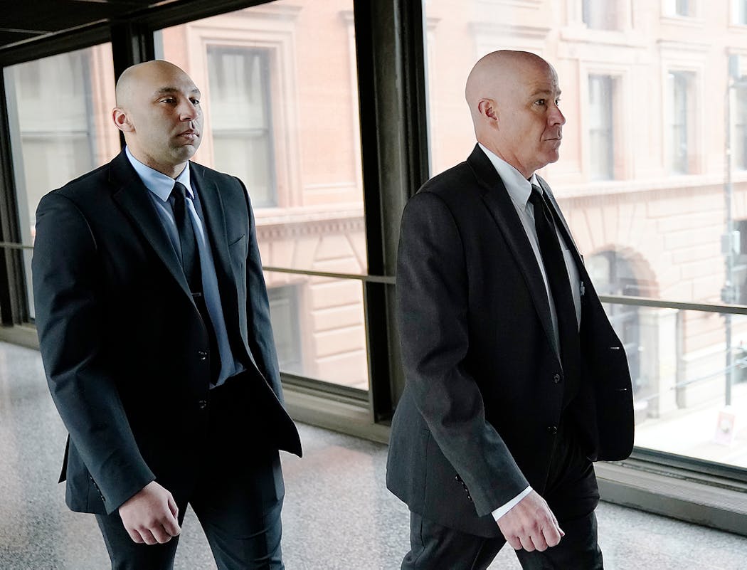 Former Minneapolis police officer J. Alexander Kueng, left, and his attorney Thomas Plunkett arrive for sentencing outside the federal courthouse Wednesday in St. Paul.