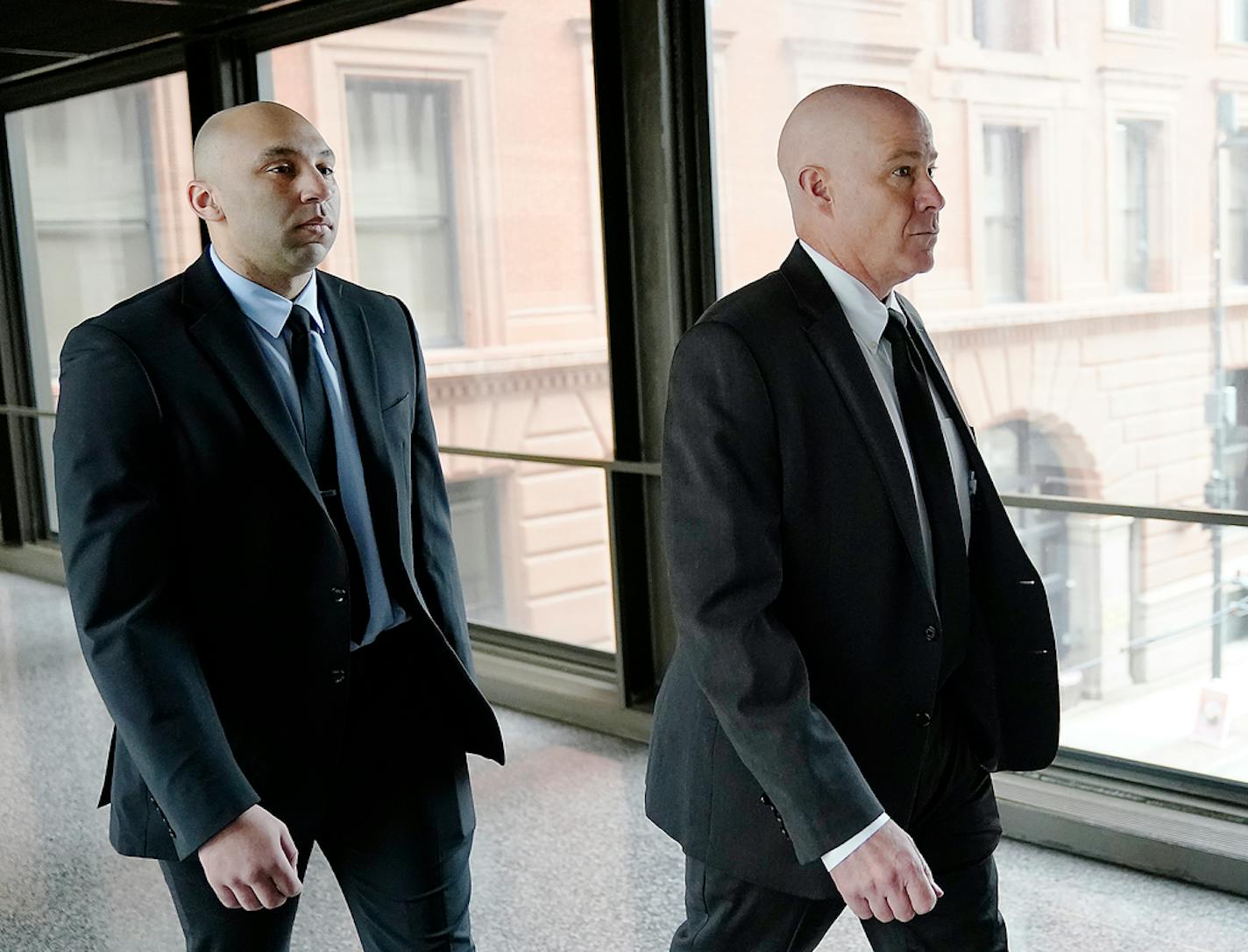 Former Minneapolis police officer J. Alexander Kueng, left, and his attorney Thomas Plunkett arrive for sentencing for violating George Floyd's civil rights outside the Federal Courthouse Wednesday, July 27, 2022 in St. Paul, Minn. ]