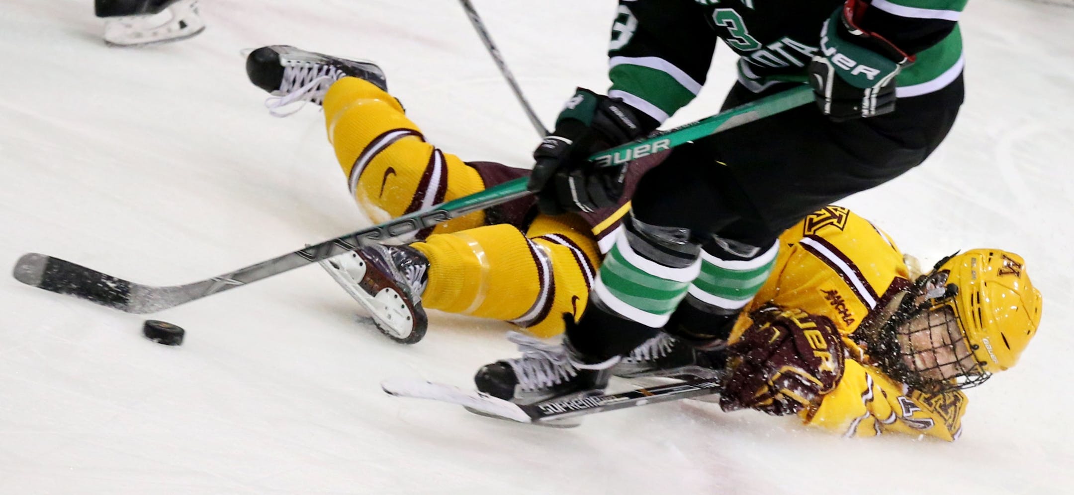 The University of Minnesota's Cara Piazza goes to the ice against North Dakota's Layla Marvin during the third period of the Gophers 3-0 win over the University of North Dakota Friday, Feb. 5, 2016, at Ridder Arena on the campus of the University of Minnesota in Minneapolis, MN.