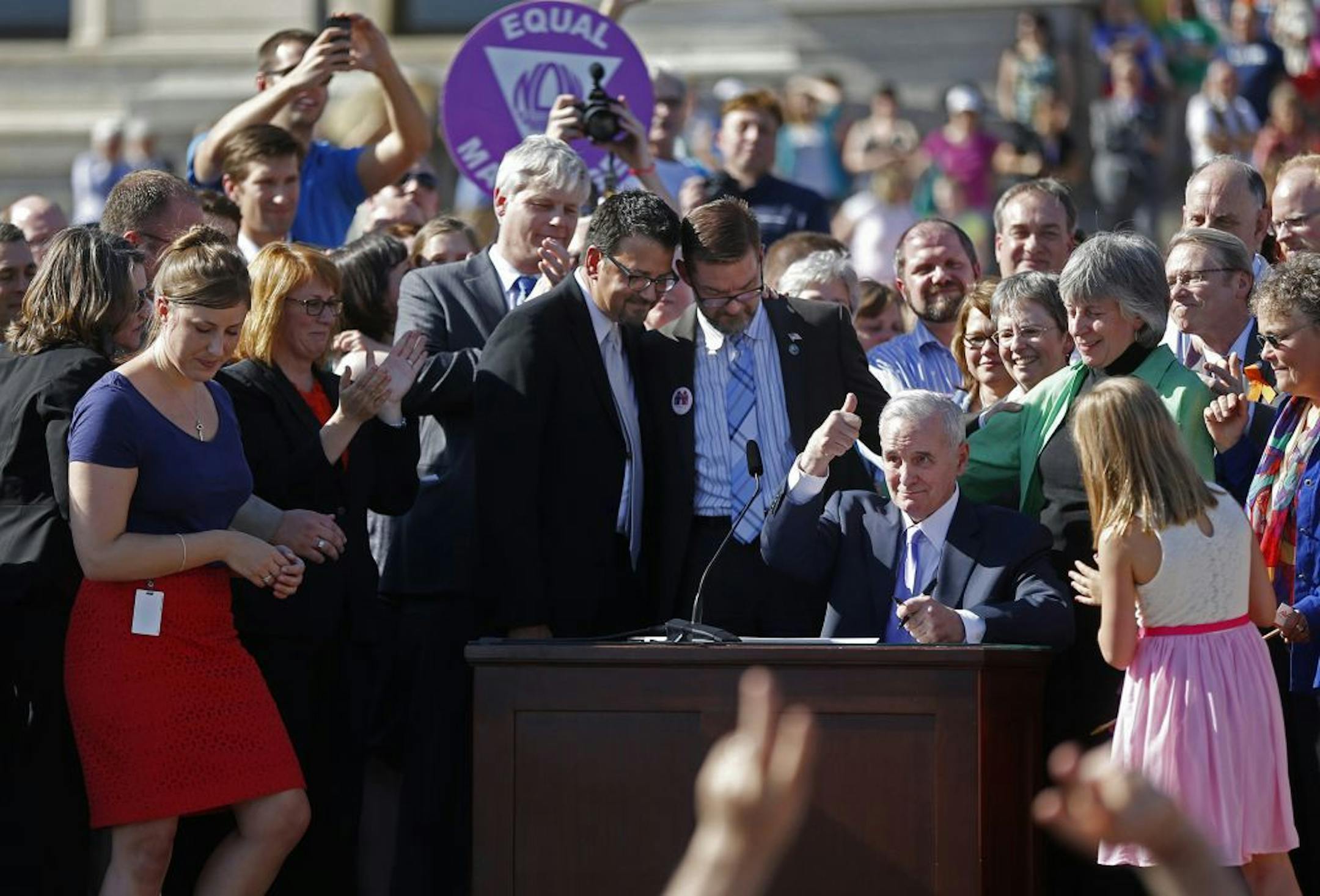 Minnesota Gov. Mark Dayton signs the same-sex marriage bill into law at the State Capitol in St. Paul, Minnesota, Tuesday, May 14, 2013. (Richard Tsong-Taatarii/Minneapolis Star Tribune/MCT) ORG XMIT: 1138728 ORG XMIT: MIN1305142016380105