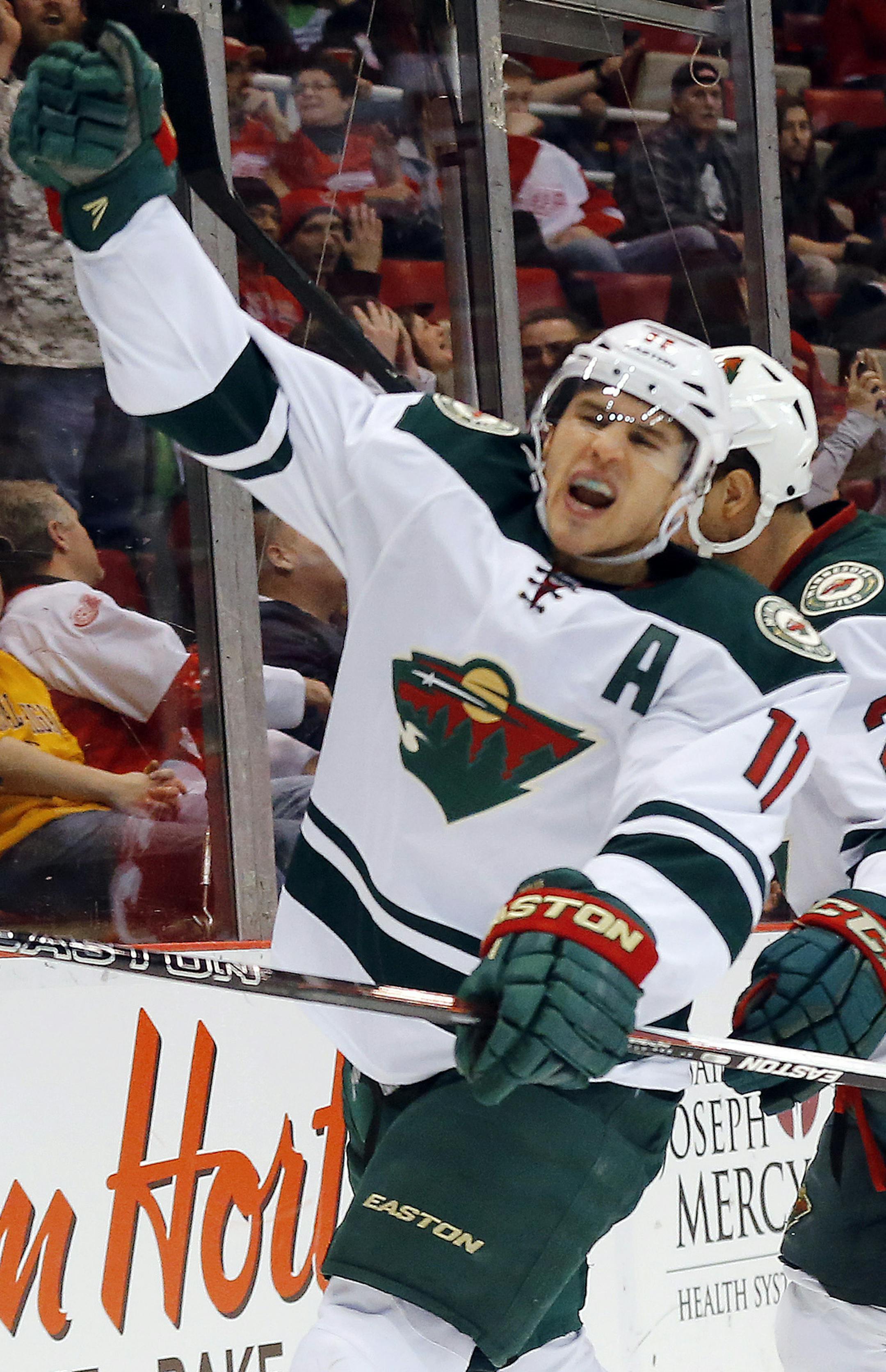 Minnesota Wild left wing Zach Parise (11) celebrates his goal against Detroit Red Wings goalie Petr Mrazek (34) in the third period of an NHL hockey game in Detroit Tuesday, Jan. 20, 2015. (AP Photo/Paul Sancya)