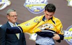 June 24, 2016: Dante Fabbro dons the Predators jersey after he was selected as the 17th pick in the first round of the 2016 NHL Entry Draft at First N