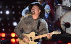 FILE - This March 14, 2019 file photo shows Garth Brooks performing at the iHeartRadio Music Awards in Los Angeles. Brooks is holding a concert in Nas