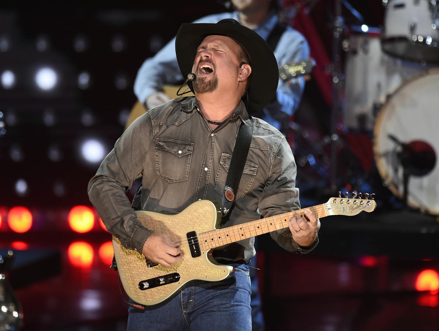 FILE - This March 14, 2019 file photo shows Garth Brooks performing at the iHeartRadio Music Awards in Los Angeles. Brooks is holding a concert in Nashville, Tenn., that will be played at 300 drive-in theaters across the country. Tickets will cost $100 per passenger car or truck. (Photo by Chris Pizzello/Invision/AP, File)