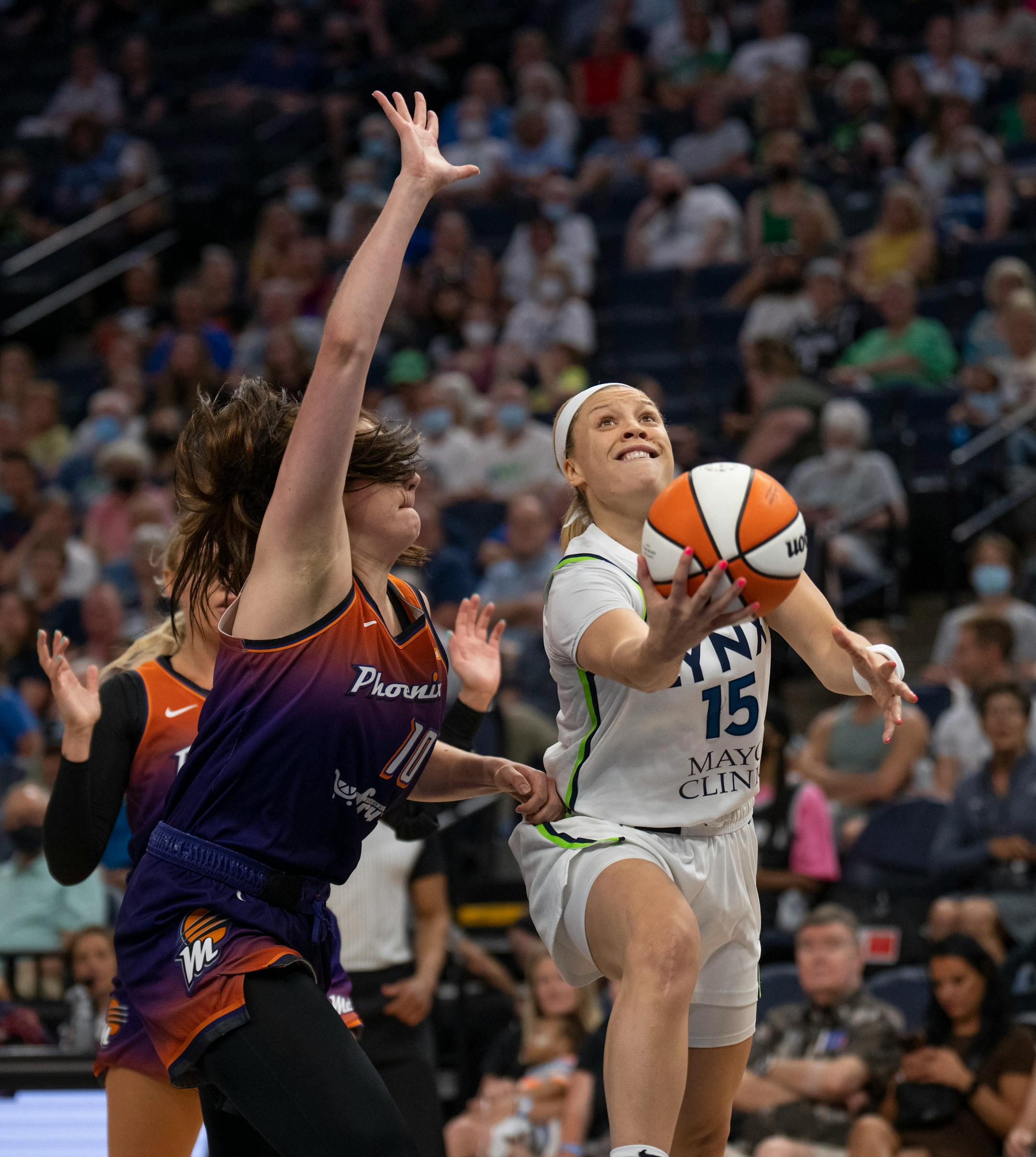 Minnesota Lynx guard Rachel Banham (15) put up a second quarter shot as she was fouled by Phoenix Mercury center Megan Gustafson (10).