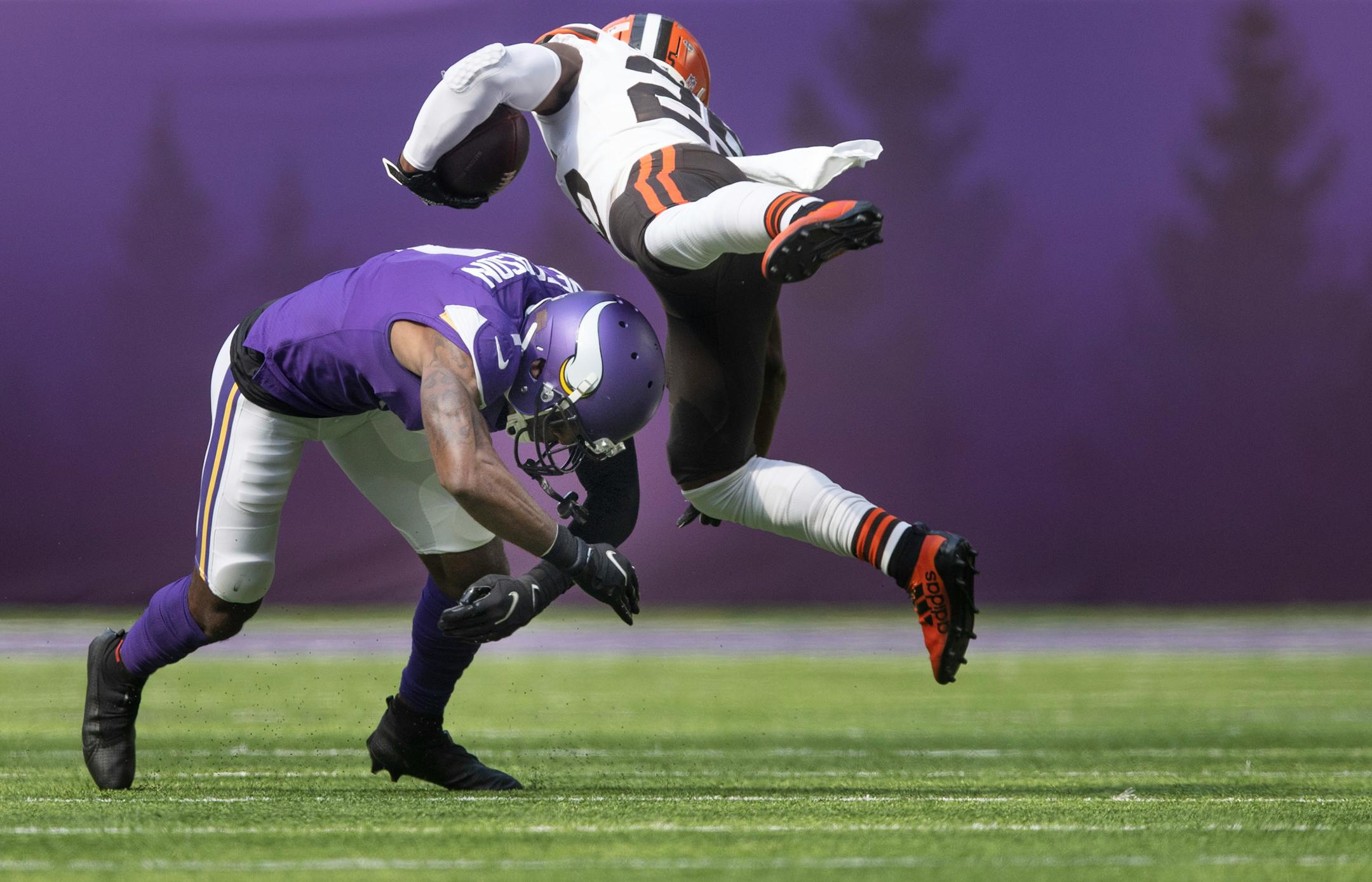 Minnesota Vikings cornerback Patrick Peterson (7) upended Cleveland Browns running back Demetric Felton (25) in the second quarter.