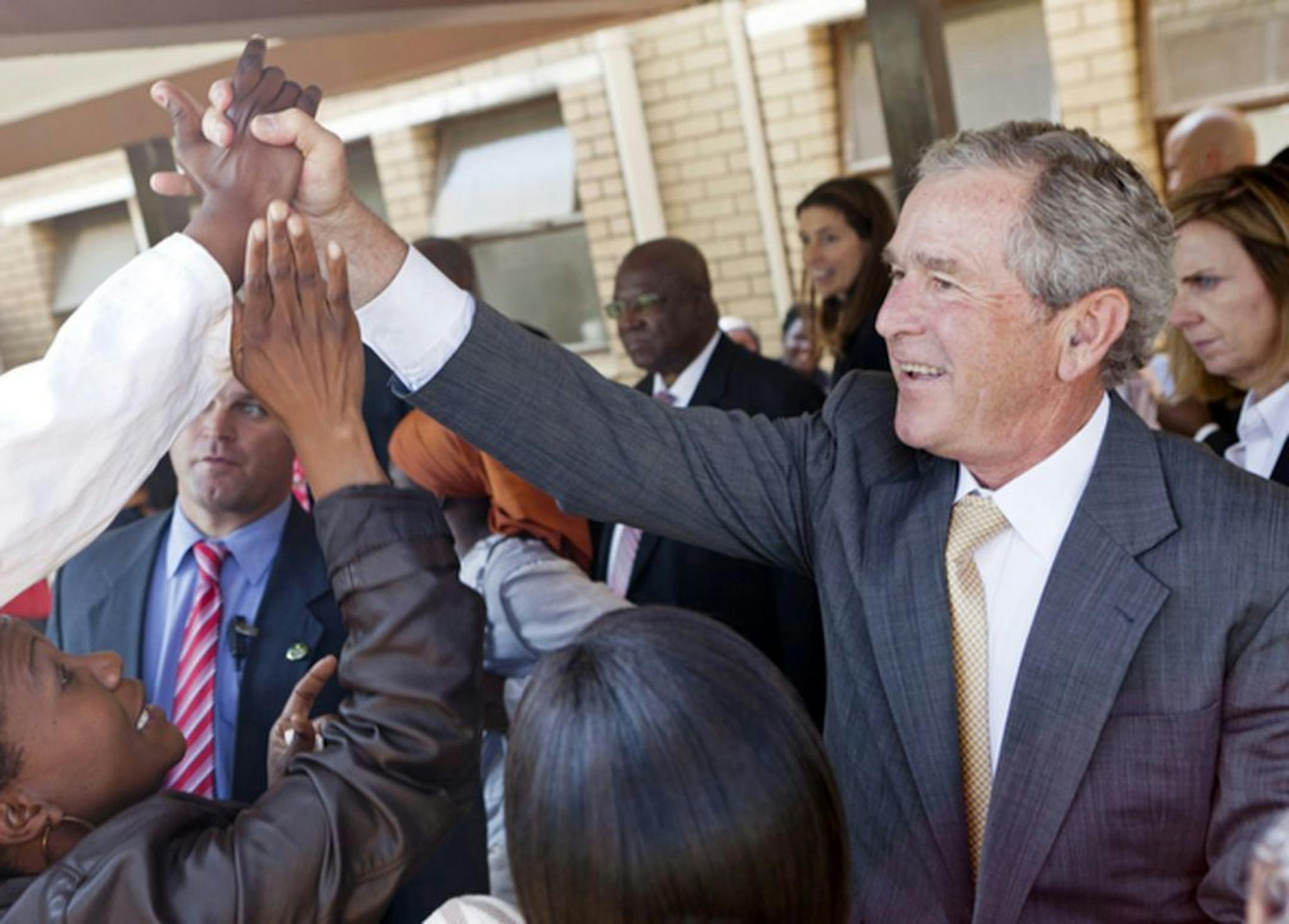 FILE - In this July 5, 2012 file photo provided by the George W. Bush Presidential Center, former President George W. Bush and his wife, Laura Bush stop to talk with people who have lined the hallways of the Princess Marina Hospital in Gaborone, Botswana. The government spent nearly $3.7 million on former presidents in 2012, according to an analysis just released by the nonpartisan Congressional Research Service. That covers a pension, compensation and benefits for office staff, and other costs