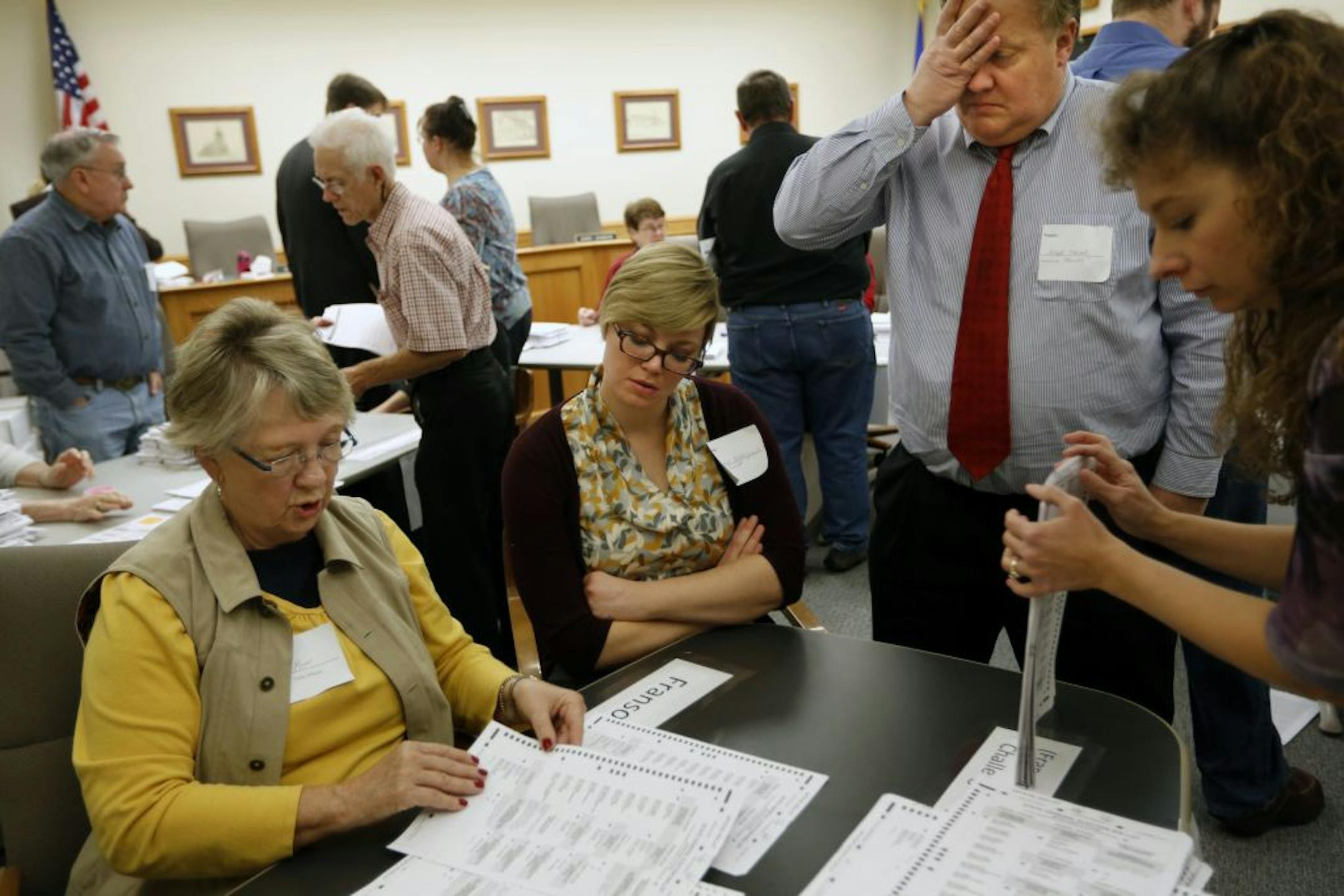 Table official Joy Moon examined a ballot as Cunniff observer Jaime Makepeace and Franson observer Joseph Marble stood by. Tara Anderson stacked ballots.