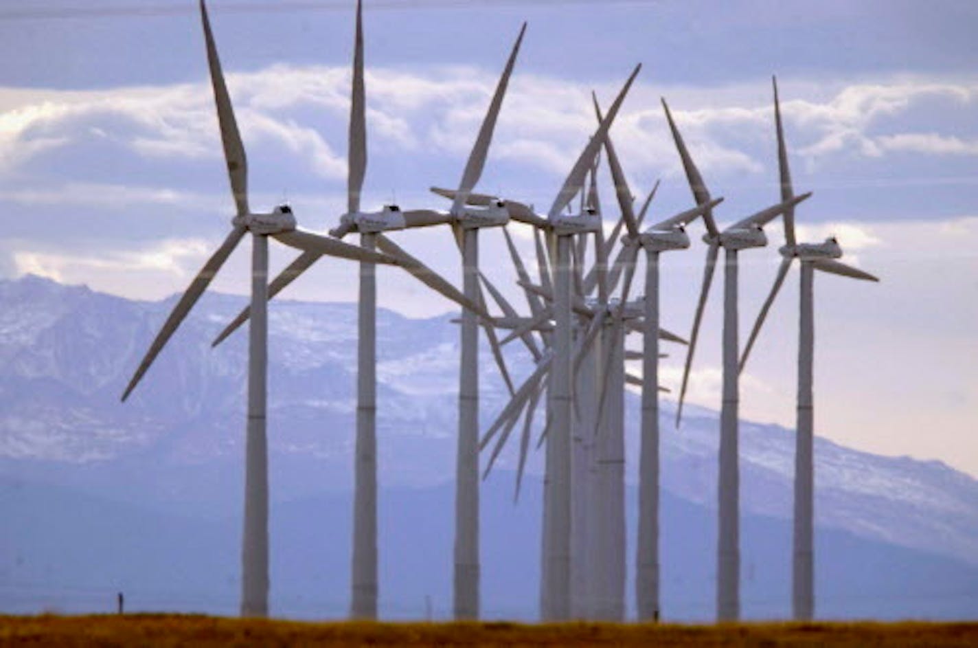 FILE - In this Oct. 10, 2002, file photo, turbines blow in the wind at an Xcel Energy wind farm on the border of Colorado and Wyoming south of Cheyenne, Wyo. Colorado regulators approved Xcel Energy's ambitious plan to nearly double the share of electricity it generates from renewable sources despite some doubts about the company's claims for how much money consumers will save. The Public Utilities Commission voted 2-1 in favor of the plan Monday, Aug. 27, 2018. (AP Photo/David Zalubowski, File)