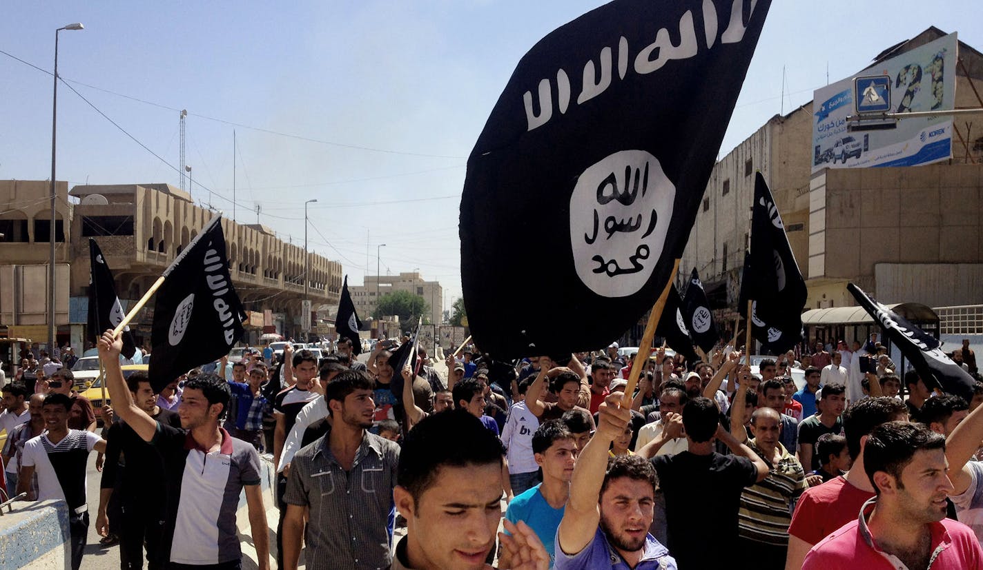 FILE - In this June 16, 2014 file photo, demonstrators chant pro-Islamic State group, slogans as they carry the group's flags in front of the provincial government headquarters in Mosul, 225 miles (360 kilometers) northwest of Baghdad. ISIS placed eighth on Google's list of 2014's fastest-rising global search requests, the company said Tuesday, Dec. 16, 2014. (AP Photo, File) ORG XMIT: NYBZ308