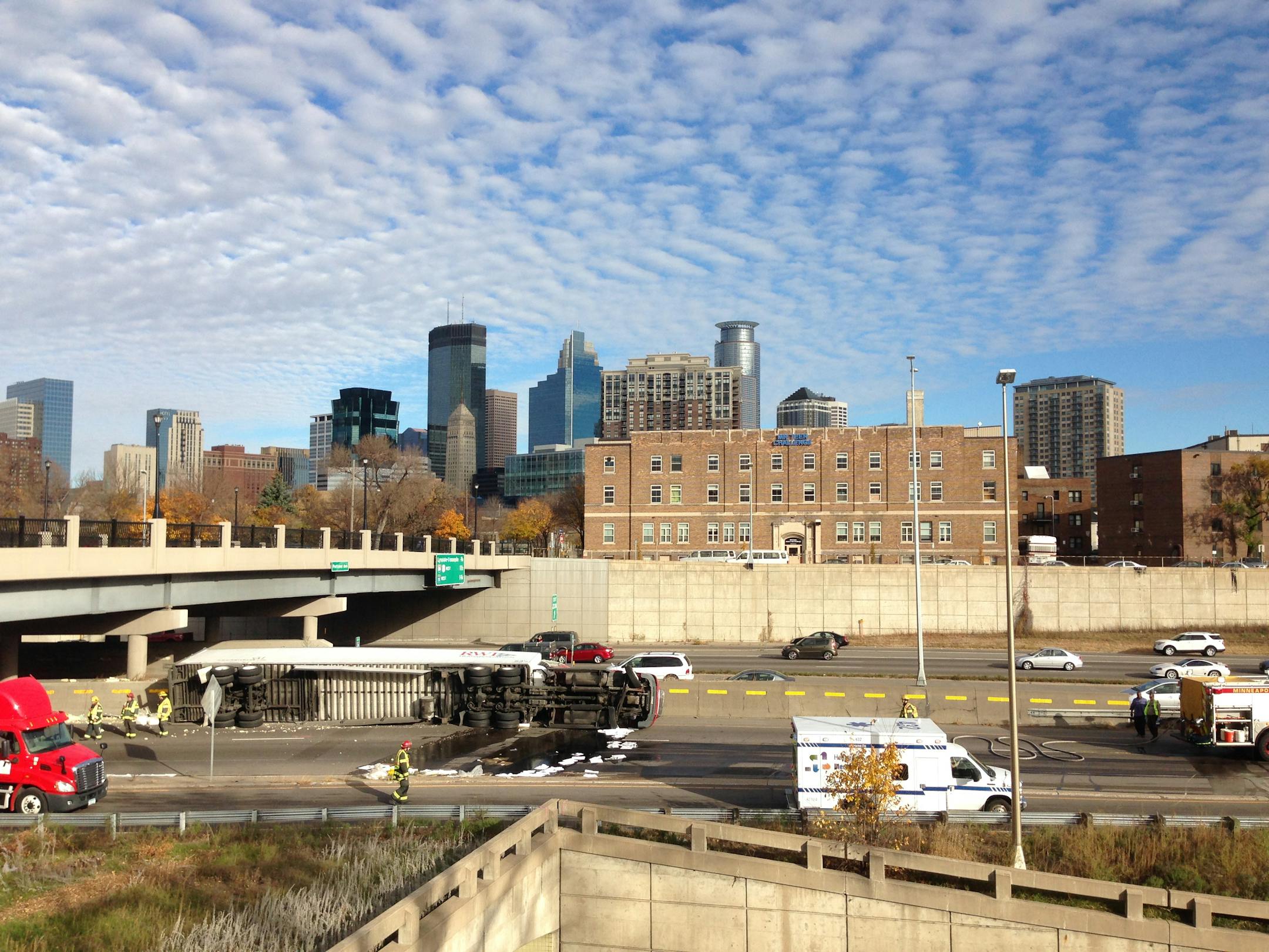 A semitrailer truck lay on its side after rolling over on northbound I-35W on the south edge of downtown Minneapolis on Saturday, Oct. 25, 2014.