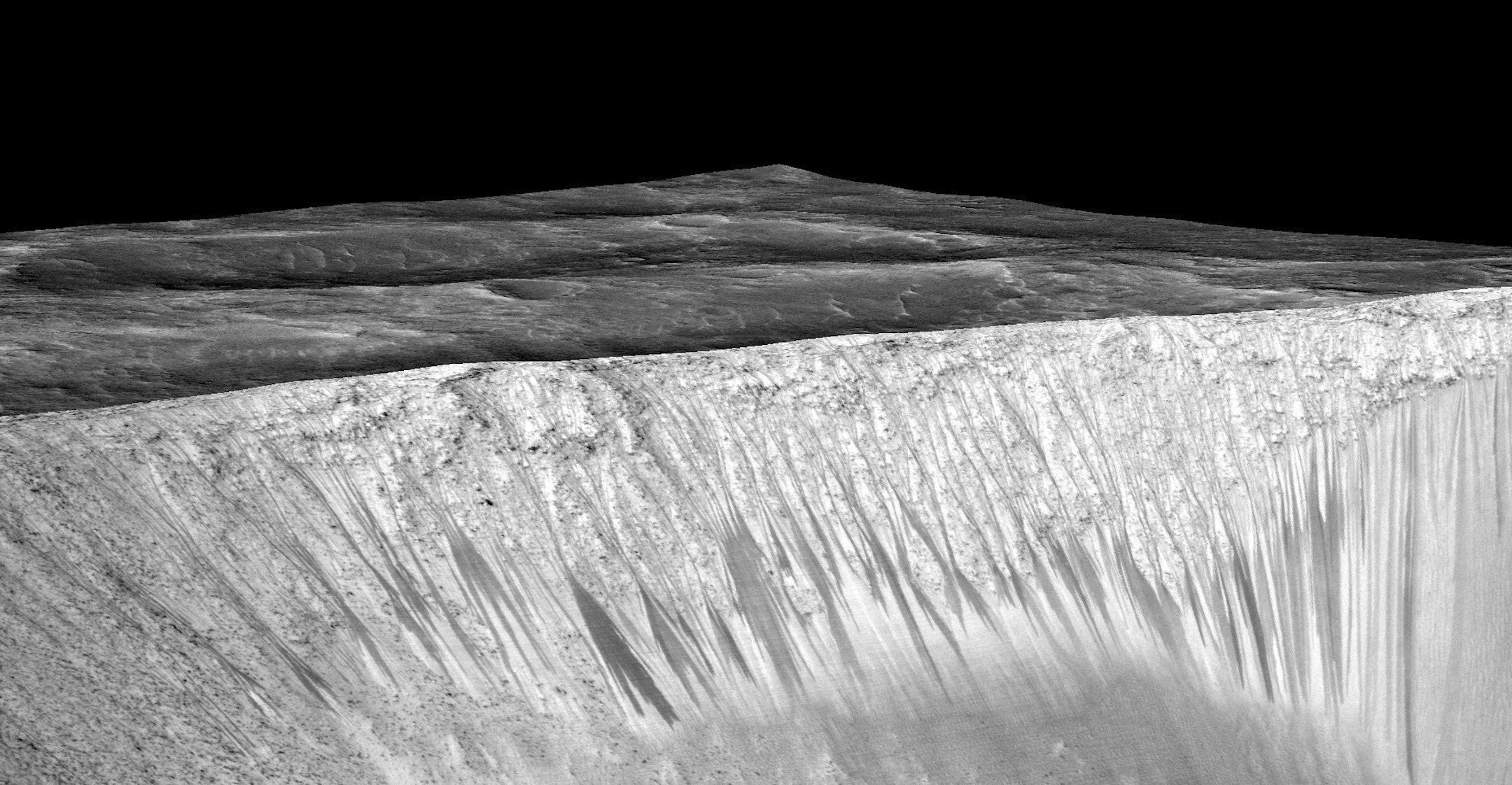 In an undated handout photo, the bright walls of Garni Crater on Mars have streaks known as recurrent slope linae. Scientists reported on Monday definitive signs of liquid water on the surface of present-day Mars, a finding that will fuel speculation that life, if it ever arose there, could persist to now. (NASA/Jet Propulsion Laboratory/University of Arizona) -- NO SALES; FOR EDITORIAL USE ONLY WITH STORY SLUGGED MARS WATER BY KENNETH CHANG. ALL OTHER USE PROHIBITED. --