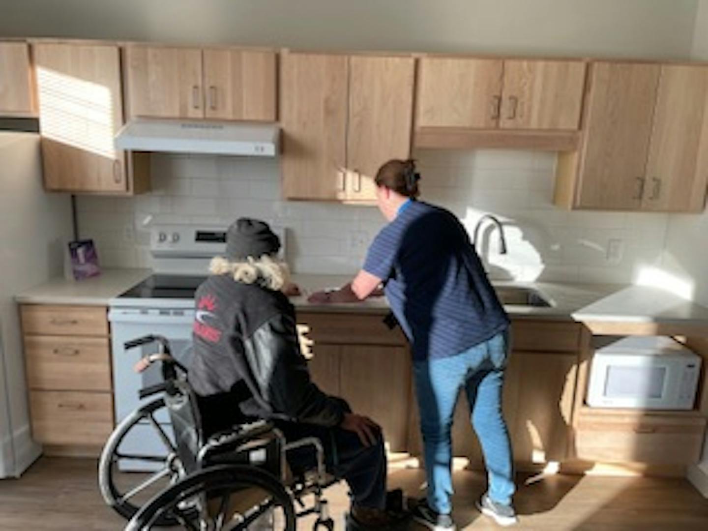 Jeff (left) tours a house placement after workers for St. Paul's Familiar Faces program connected him with city services.