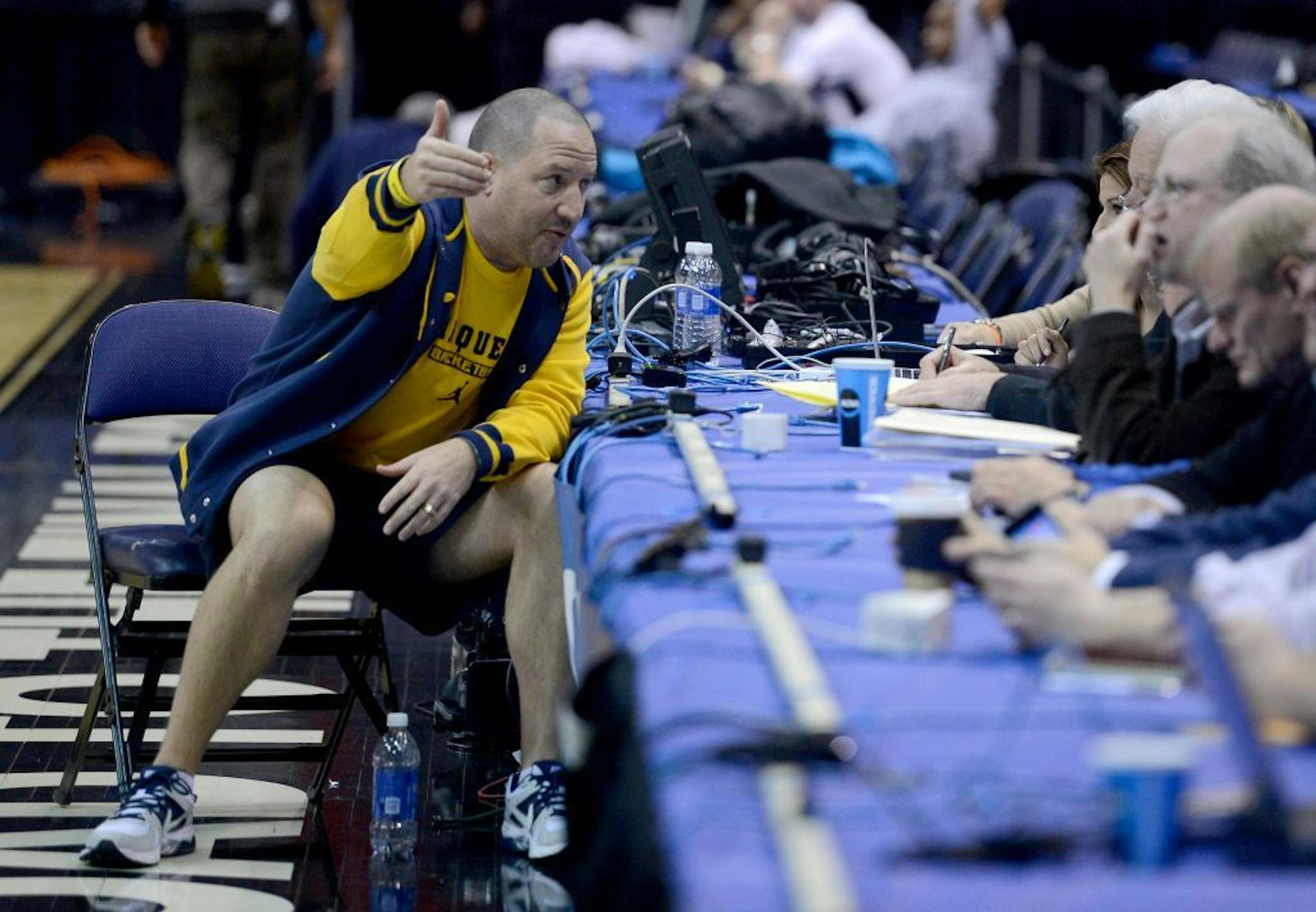 Marquette head coach Buzz Williams, left, speaks with reporters court side during a team shoot around last week.